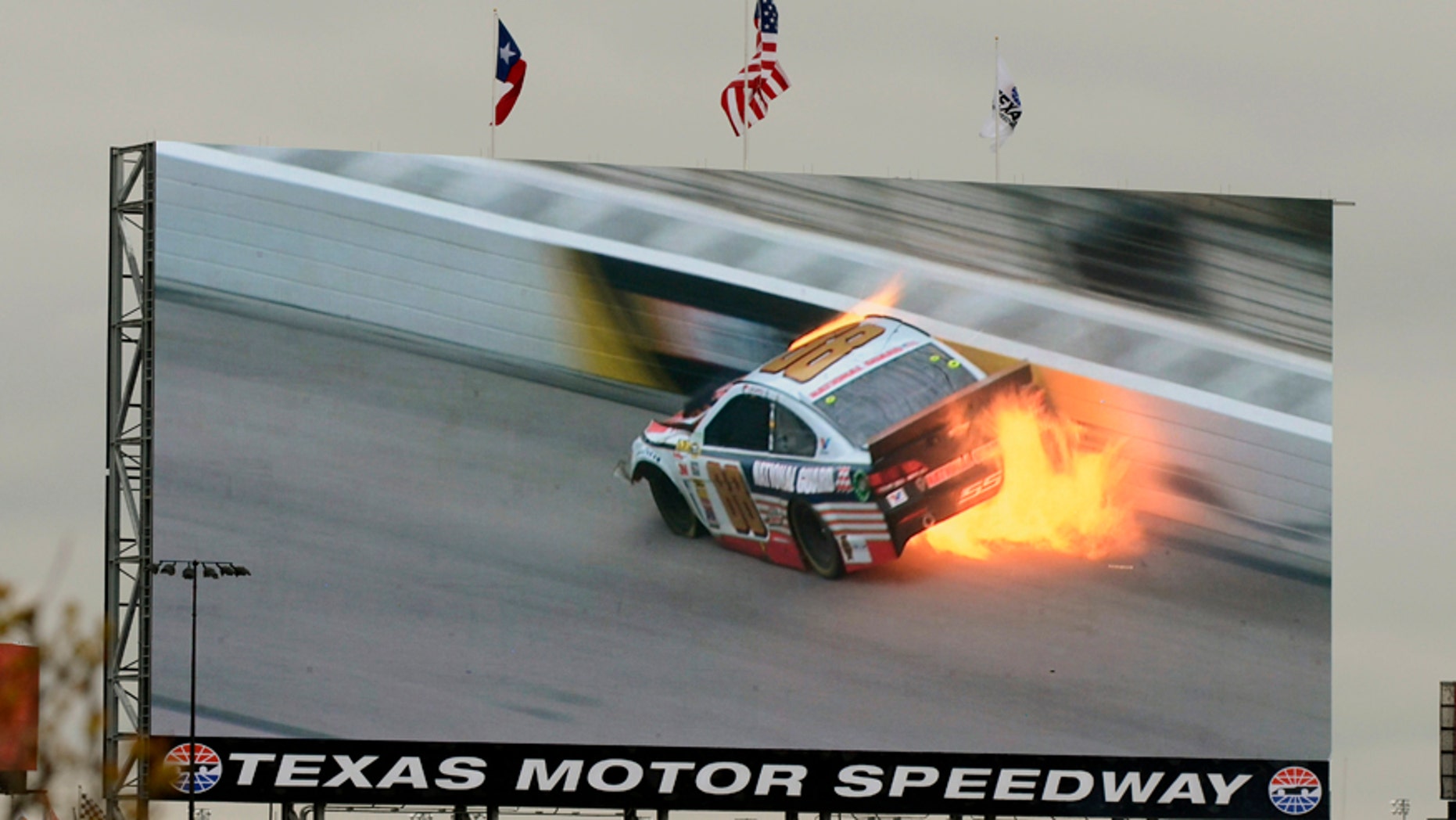 A video screen shows a replay of Dale Earnhardt Jr.'s (88) car during a wreck at the NASCAR Sprint Cup series auto race at Texas Motor Speedway, Monday, April 7, 2014, in Fort Worth, Texas. (AP Photo/Larry Papke)
