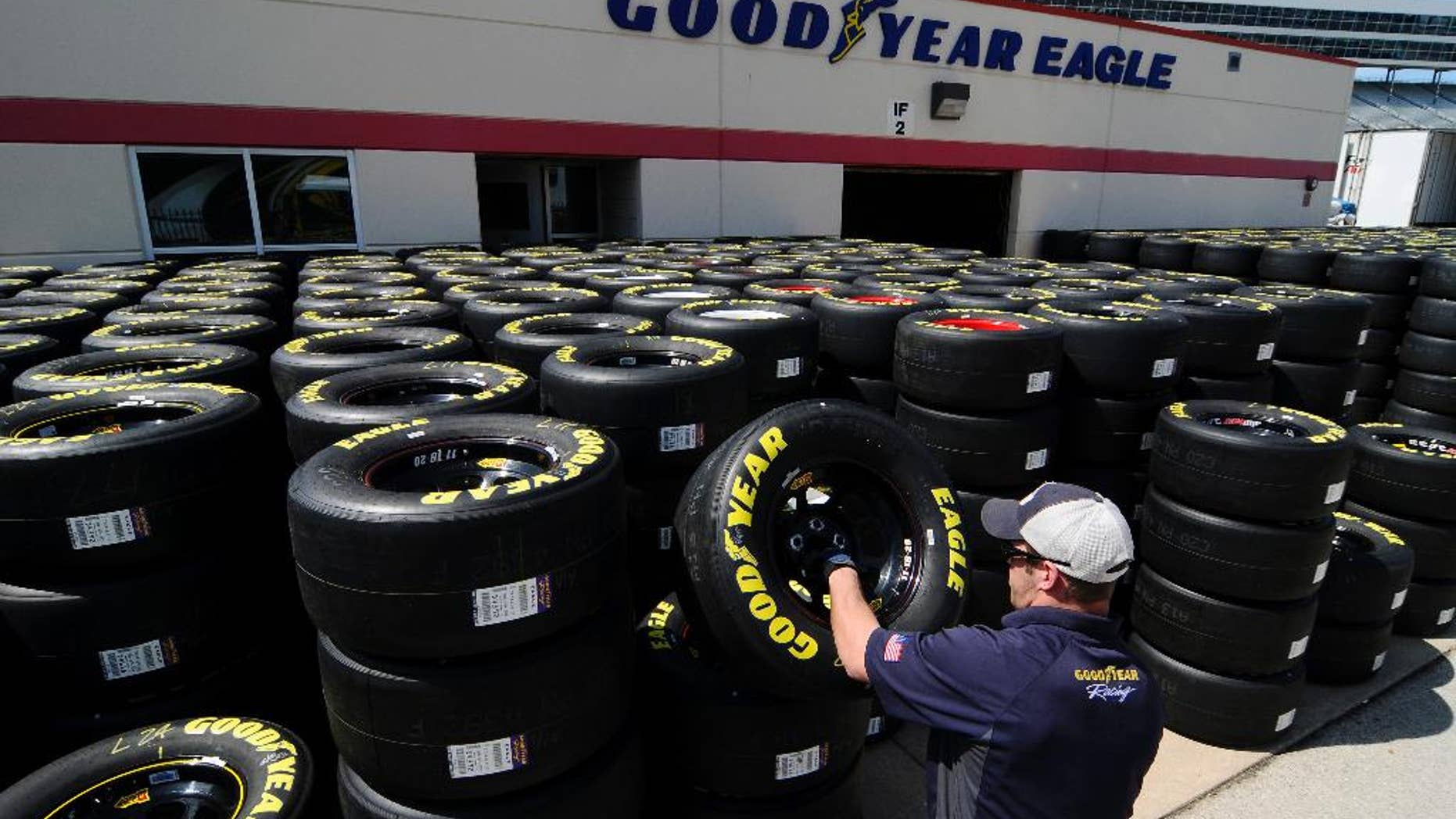 Brayden Wienke stacks tires at Texas Motor Speedway in Fort Worth, Texas, Friday, April 4, 2014. NASCAR will not regulate tire pressures at the speedway, and if drivers have tire failures during Sunday's race officials believe they will not be able to blame Goodyear. (AP Photo/Ralph Lauer)