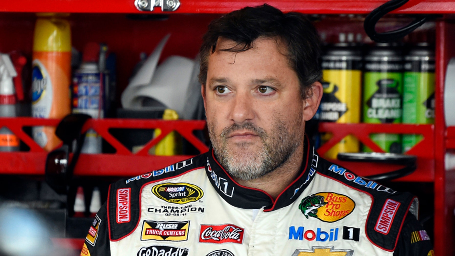 FILE - In this Sept. 13, 2014, file photo, Tony Stewart looks out from his garage during practice for the NASCAR Sprint Cup series auto race at Chicagoland Speedway in Joliet, Ill. A grand jury decided against charging Stewart in the death of Kevin Ward Jr. on a dirt track last month in upstate New York. Stewart took three weeks off from racing after the crash. (AP Photo/Paul J. Bergstrom, File)