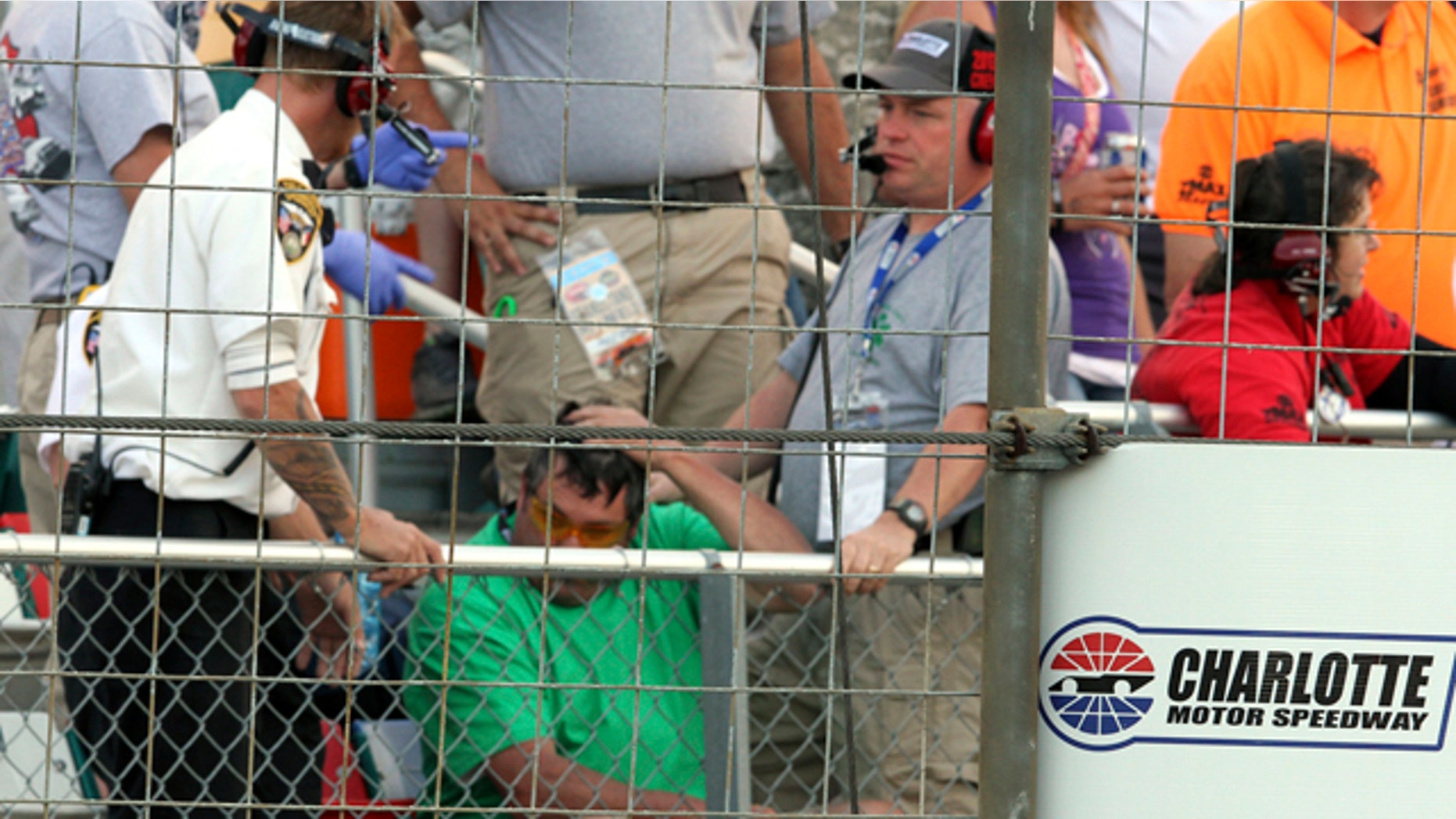 May 26, 2013: Security personnel assist a fan injured by a broken television camera cable during the NASCAR Sprint Cup series Coca-Cola 600 auto race at Charlotte Motor Speedway in Concord, N.C.