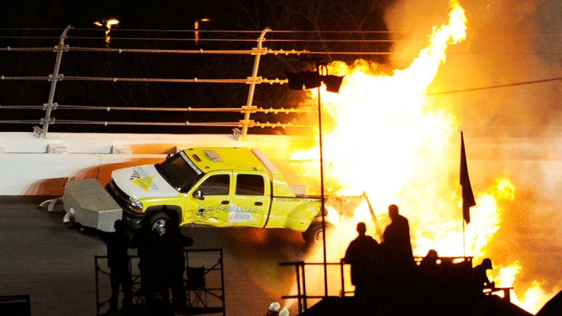 DAYTONA BEACH, FL - FEBRUARY 27: Safety workers try to extinguish a fire from a jet dryer after being hit by Juan Pablo Montoya, driver of the #42 Target Chevrolet, under caution during the NASCAR Sprint Cup Series Daytona 500 at Daytona International Speedway on February 27, 2012 in Daytona Beach, Florida. (Photo by John Harrelson/Getty Images for NASCAR)