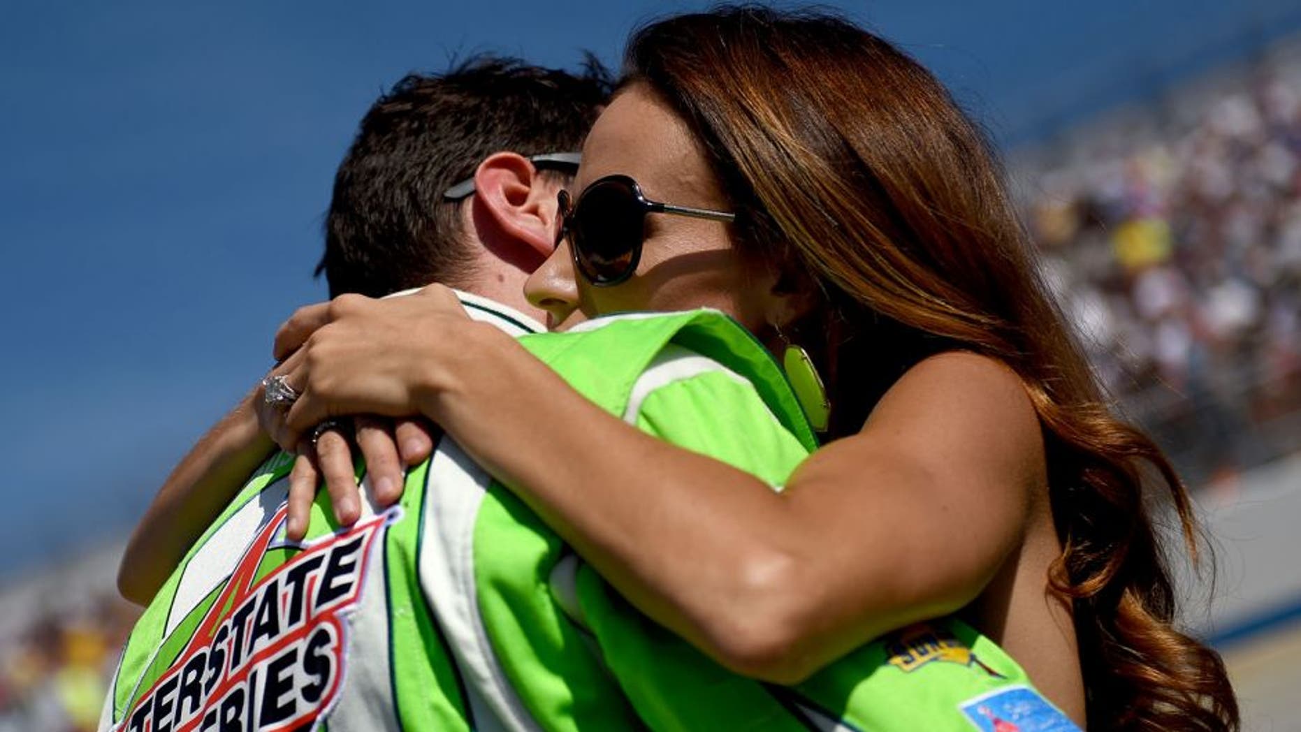 DOVER, DE - SEPTEMBER 28: Kyle Busch (L), driver of the #18 Interstate Batteries Toyota, hugs his wife Samantha (R) on the grid prior to the NASCAR Sprint Cup Series AAA 400 at Dover International Speedway on September 28, 2014 in Dover, Delaware. (Photo by Patrick Smith/Getty Images)
