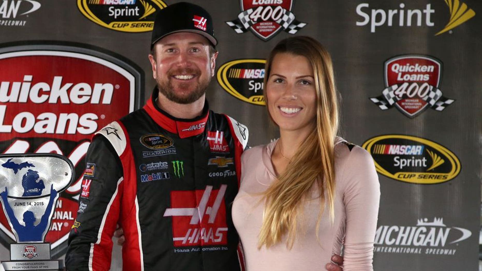BROOKLYN, MI - JUNE 14: Kurt Busch, driver of the #41 Haas Automation Chevrolet, and his girlfriend Ashley Van Metre celebrate in an alternate Victory Lane after winning the NASCAR Sprint Cup Series Quicken Loans 400 at Michigan International Speedway on June 14, 2015 in Brooklyn, Michigan. (Photo by Sean Gardner/NASCAR via Getty Images)