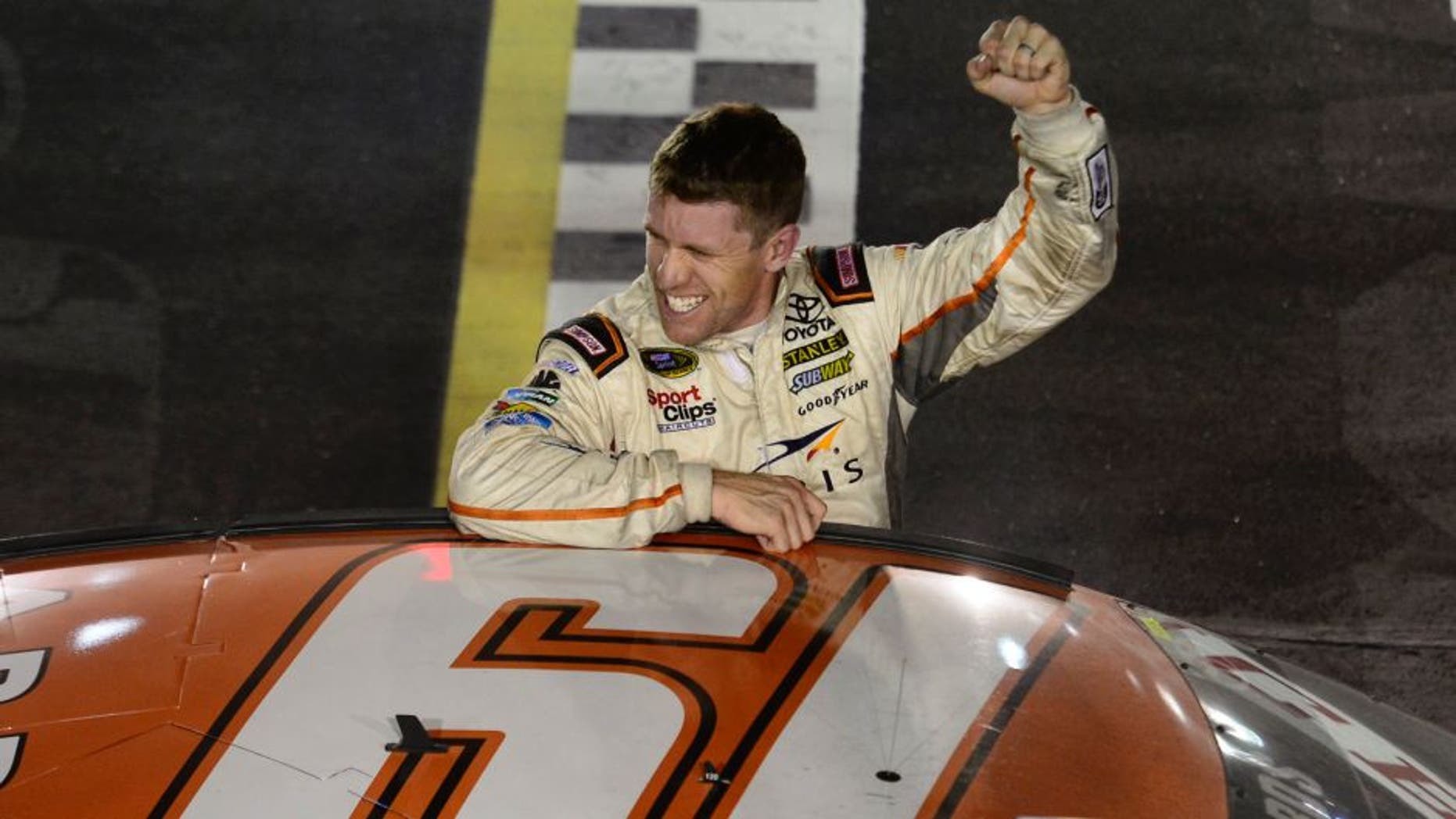 DARLINGTON, SC - SEPTEMBER 06: Carl Edwards, driver of the #19 ARRIS Toyota, salutes the crowd after winning the NASCAR Sprint Cup Series Bojangles' Southern 500 at Darlington Raceway on September 6, 2015 in Darlington, South Carolina. (Photo by Robert Laberge/NASCAR via Getty Images)