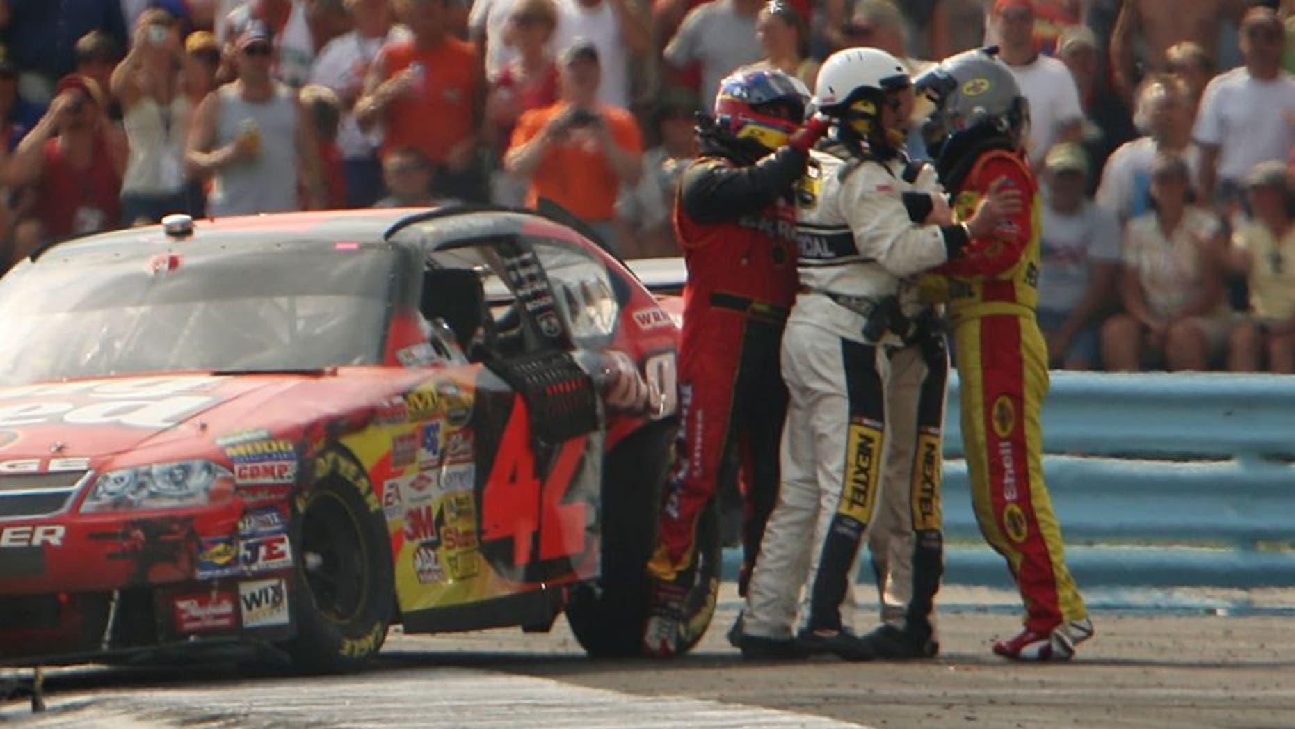 WATKINS GLEN, NY - AUGUST 12: Kevin Harvick, driver of the #29 Shell/Pennzoil Chevrolet, and Juan Pablo Montoya, driver of the #42 Wrigley's Big Red Dodge, are separated by NASCAR officials after the two collided during the NASCAR Nextel Cup Series Centurion Boats at The Glen at Watkins Glen International on August 12, 2007 in Watkins Glen, New York. (Photo by Chris McGrath/Getty Images) *** Local Caption *** Juan Pablo Montoya;Kevin Harvick
