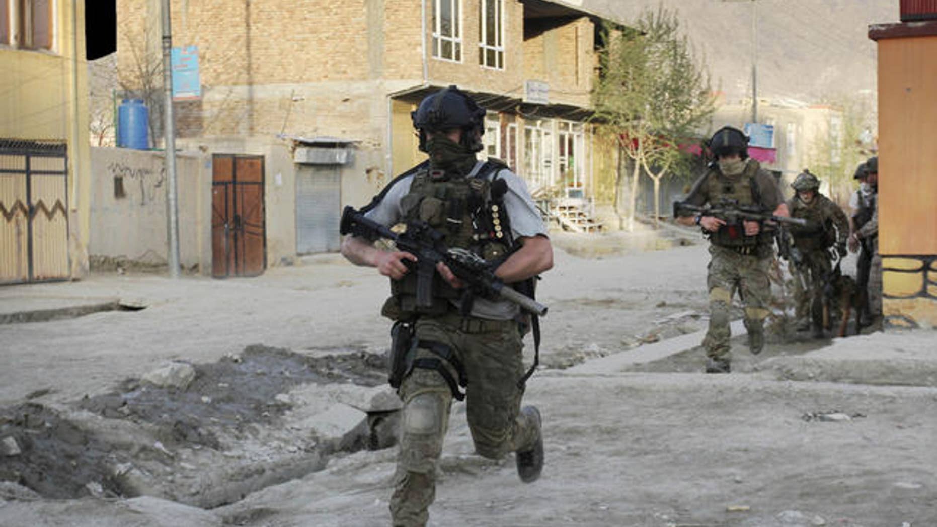 April 15, 2012: NATO soldiers run during a gun battle in Kabul, Afghanistan.