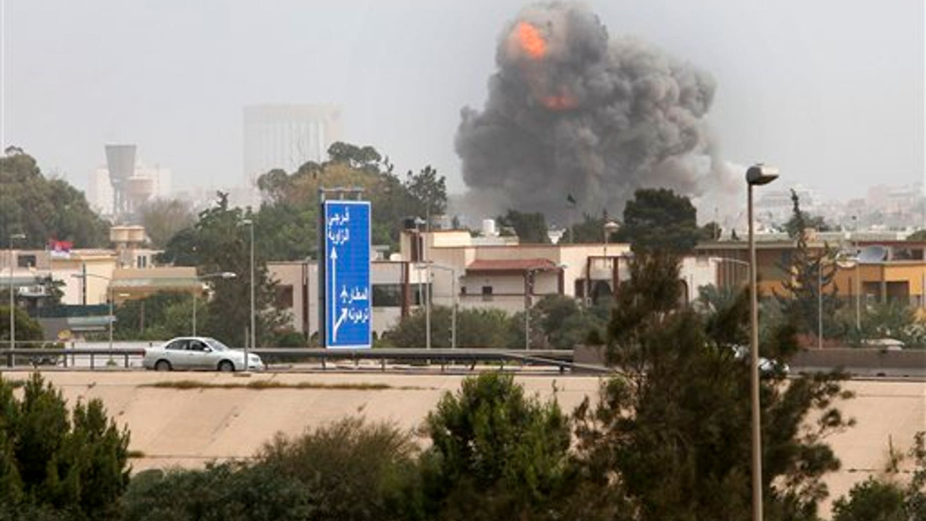 June 7: A smoke and dust cloud from an explosion rises into the sky after a NATO airstrike in Tripoli, Libya. Muammar al-Qaddafi vowed to fight to the death in a defiant speech Tuesday after NATO military craft unleashed a ferocious series of daytime airstrikes on Tripoli. (AP)