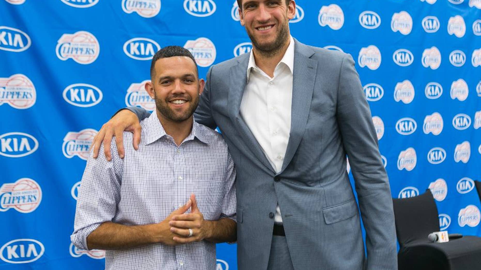 Free agent guard Jordan Farmar, left, and center Spencer Hawes are introduced as the new Los Angeles Clippers players during a news conference in Los Angeles Thursday, July 10, 2014. (AP Photo/Damian Dovarganes)
