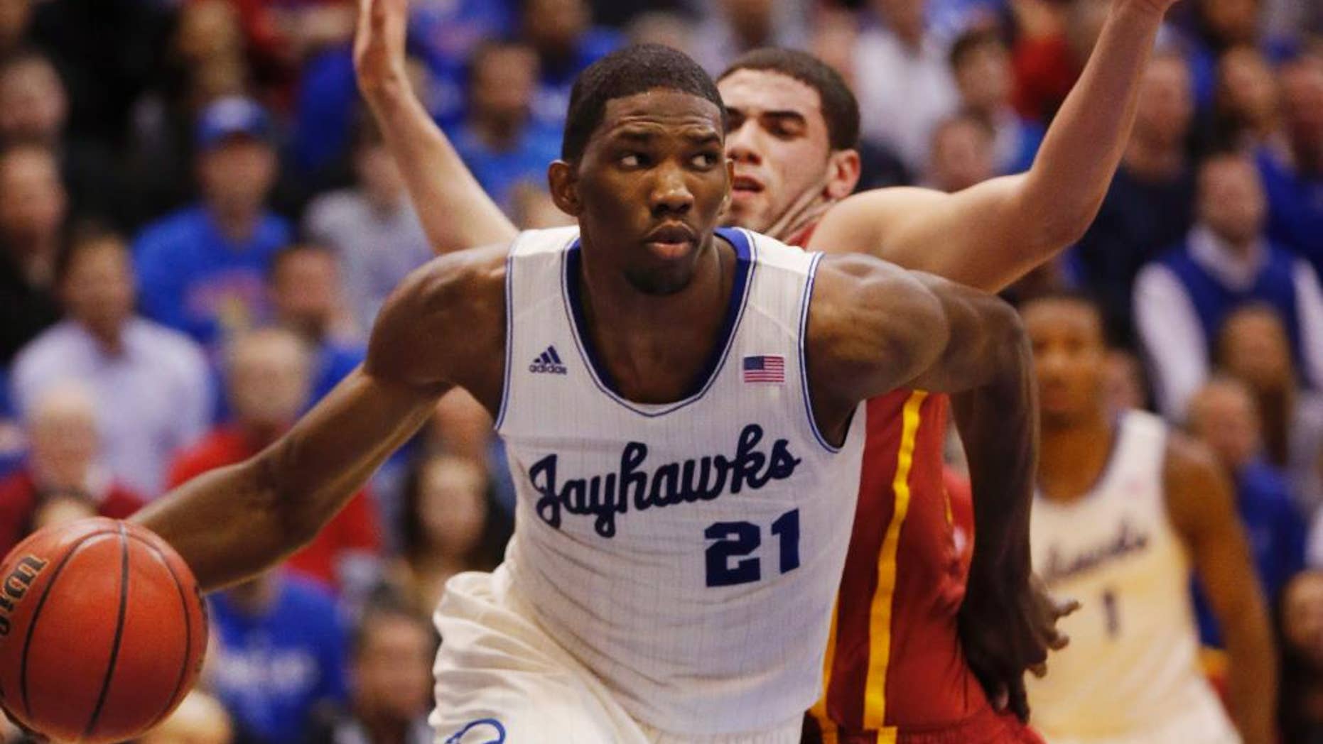 FILE - In this Jan. 29, 2014 file photo, Kansas center Joel Embiid (21) works around Iowa State forward Georges Niang, back, during the first half of an NCAA college basketball game in Lawrence, Kan. Embiid's hope of being the No. 1 pick in the 2014 NBA Draft is almost certainly gone now because of his foot injury.(AP Photo/Orlin Wagner, File)
