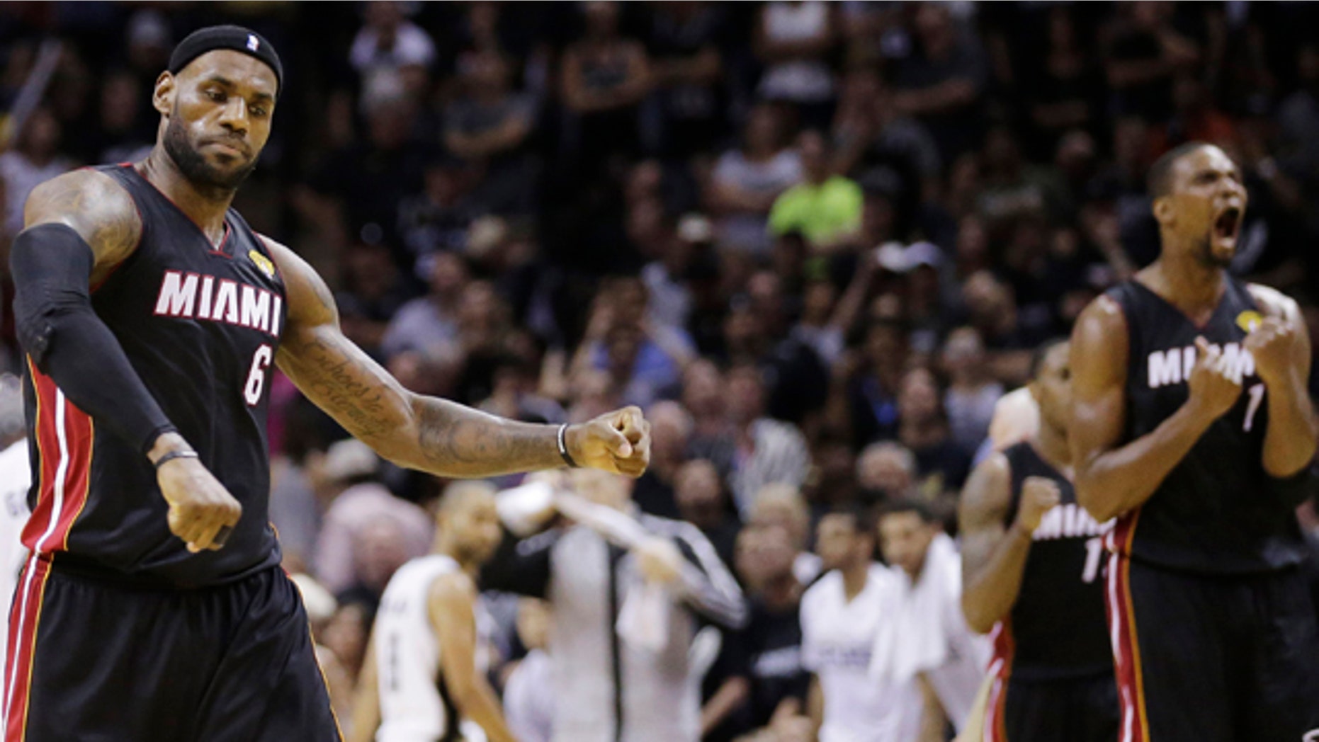 June 8, 2014: Miami Heat forward LeBron James (6) and center Chris Bosh (1) react after Game 2 of the NBA Finals in San Antonio. Miami won 98-96. (AP Photo/Eric Gay)