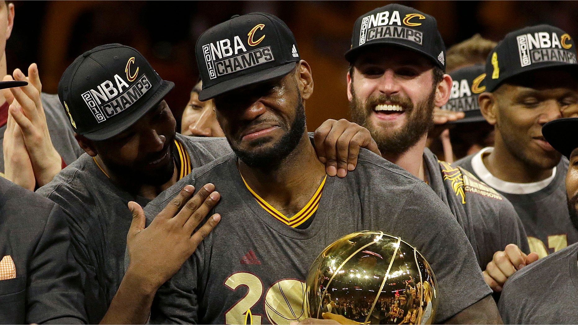 Cleveland Cavaliers forward LeBron James, center, celebrates with teammates after Game 7 of basketball's NBA Finals against the Golden State Warriors in Oakland, Calif., Sunday, June 19, 2016. The Cavaliers won 93-89. (AP Photo/Marcio Jose Sanchez)