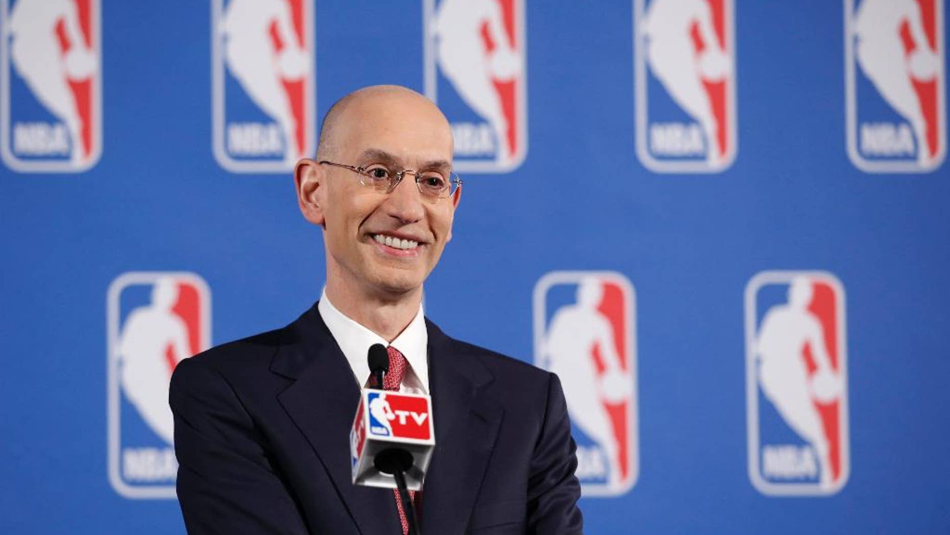 FILE - In this May 20, 2014, file photo, NBA Commissioner Adam Silver answers questions from the media during a news conference before the NBA Draft Lottery in New York. Speaking to The Associated Press on Friday, June 6, 2014, at an NBA Cares event, Silver said he's thrilled that the league's attention can be on the championship series between the Miami Heat and San Antonio Spurs _ and not, as it was for so much of the postseason, on the off-the-court matters involving the banishment of Los Angeles Clippers owner Donald Sterling and now the looming sale of that franchise. (AP Photo/Kathy Willens, File)