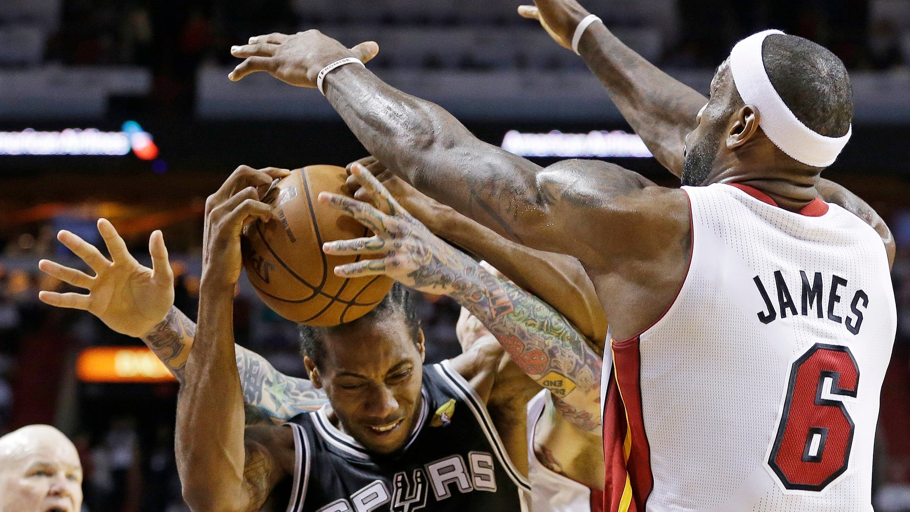 The Miami Heat's LeBron James (6) and Chris Andersen (11) defend San Antonio Spurs small forward Kawhi Leonard (2) during the first half of Game 2 of the NBA Finals basketball game, Sunday, June 9, 2013 in Miami. (AP Photo/Lynne Sladky)