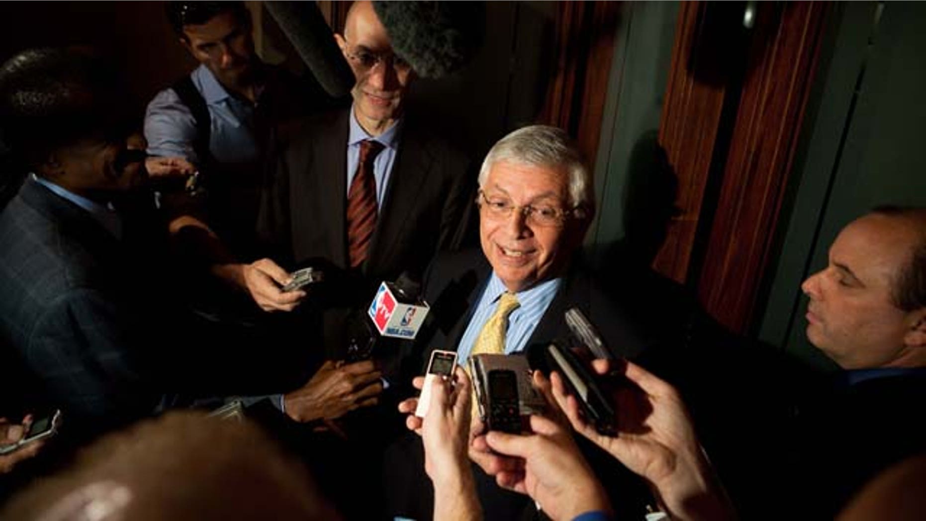NBA Commissioner David Stern, center, speaks to reporters after a meeting between the NBA Players Association and owners to discuss a new labor deal and possibly avert a lockout, Friday, Sept. 30, 2011, in New York. (AP Photo/John Minchillo)