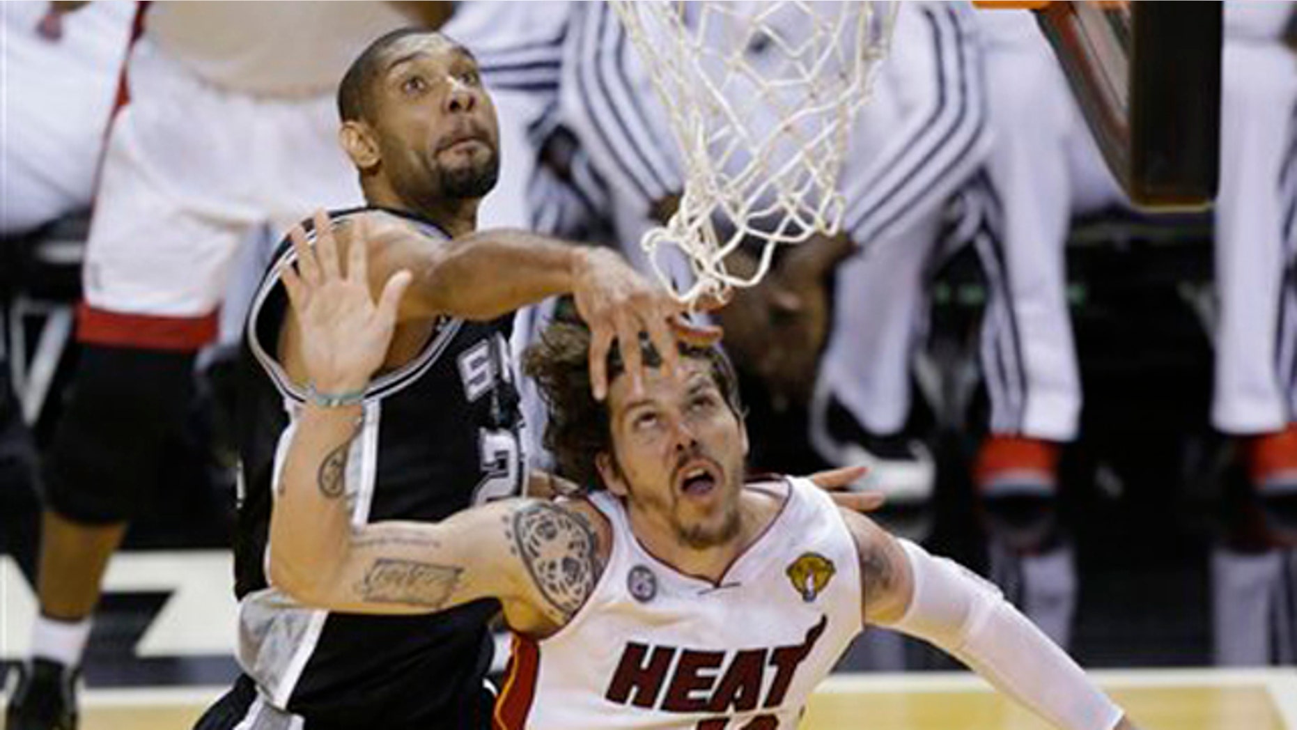 June 18, 2013: San Antonio Spurs power forward Tim Duncan (21) blocks the shot of Miami Heat shooting guard Mike Miller (13) during the second half of Game 6 of the NBA Finals basketball game.