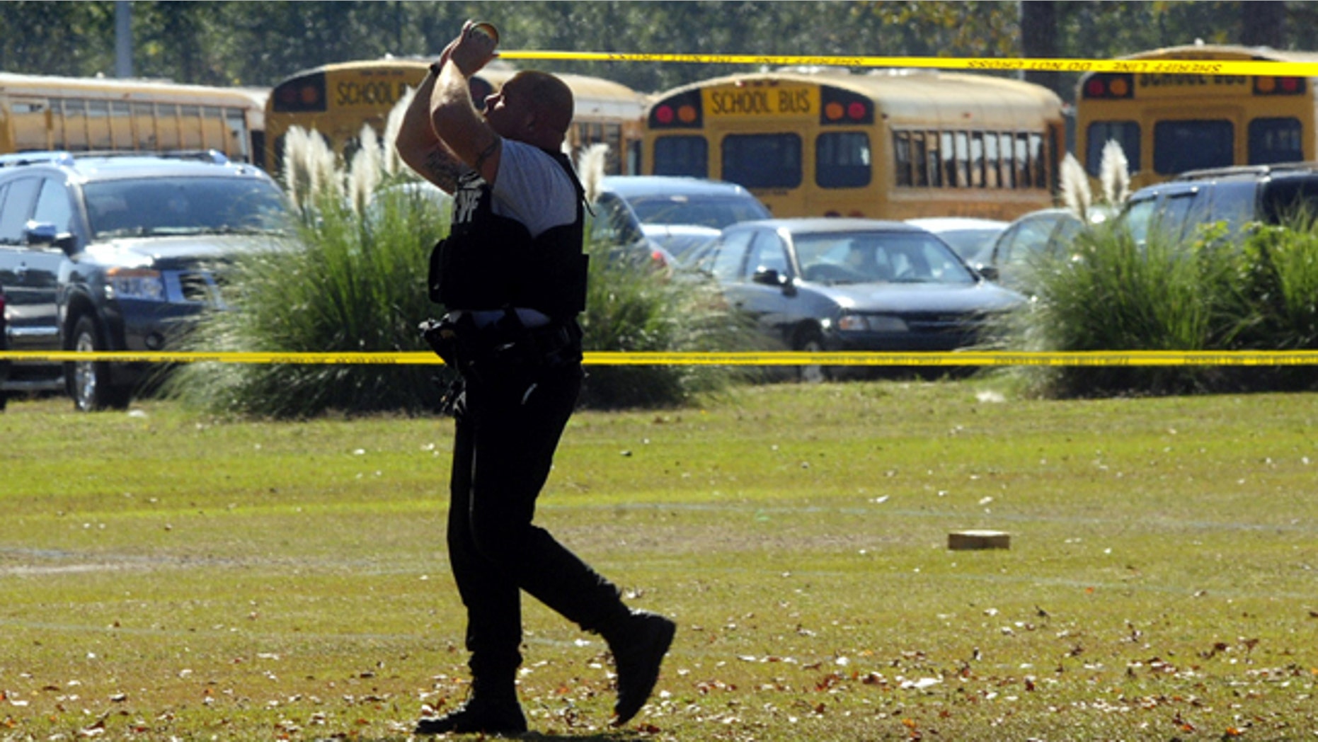 Oct. 24: A Cumberland County Sheriffs deputy rolls crime scene tape around the scene after a shooting at Cape Fear High School east of Fayetteville.