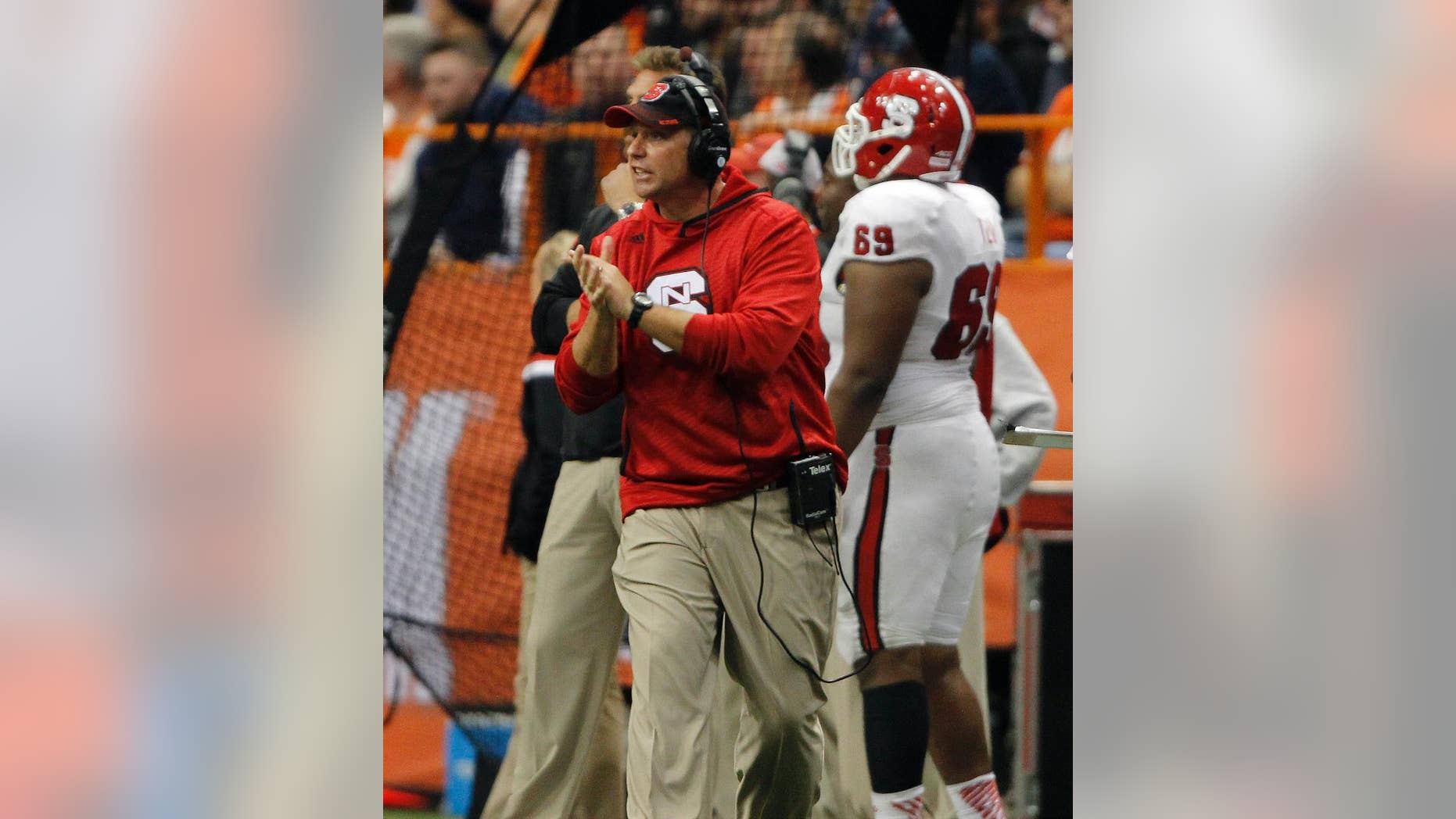 North Carolina State’s head coach Dave Doeren calls out to his players in the third quarter of an NCAA college football game against Syracuse in Syracuse, N.Y., Saturday, Nov. 1, 2014. North Carolina State won 24-17. (AP Photo/Nick Lisi)