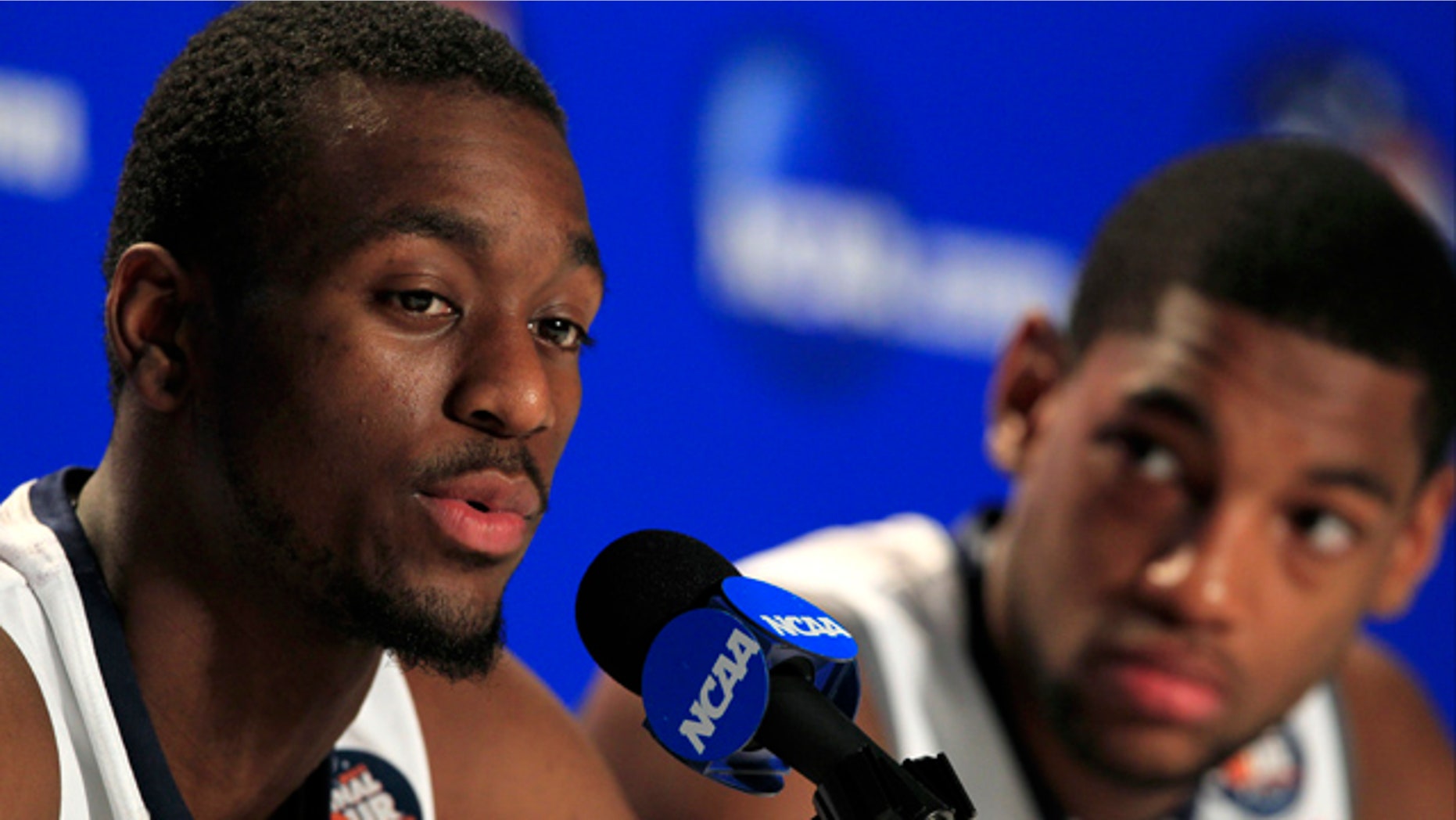April 3, 2011: Connecticut's Kemba Walker, left, speaks during a news conference as teammate Roscoe Smith looks on before a practice session for the men's NCAA Final Four college basketball championship game in Houston.