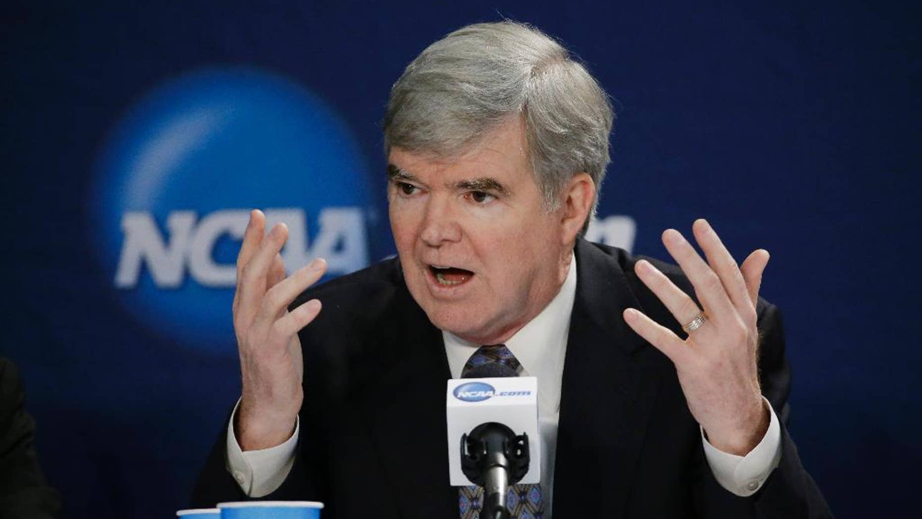 FILE - In this April 6, 2014 file photo, NCAA President Mark Emmert answers a question at a news conference in Arlington, Texas. The NCAA's board of directors is scheduled to discuss and endorse a 57-page overhaul plan that would hand far more power to five major conferences to decide how to treat and perhaps satisfy their athletes.(AP Photo/David J. Phillip, File)