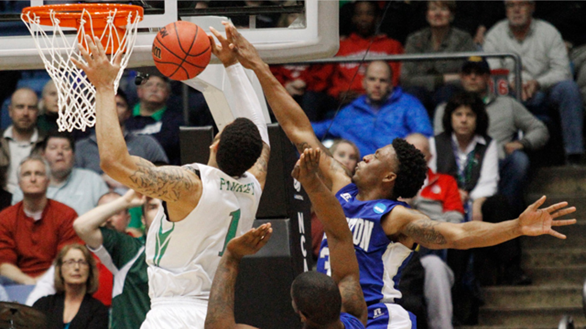 March 17, 2015: Hampton's Reginald Johnson, right, blocks a shot by Manhattan's Ashton Pankey (1) in the second half of a first round NCAA tournament basketball game Tuesday, March 17, 2015 in Dayton, Ohio. (AP Photo/Skip Peterson)