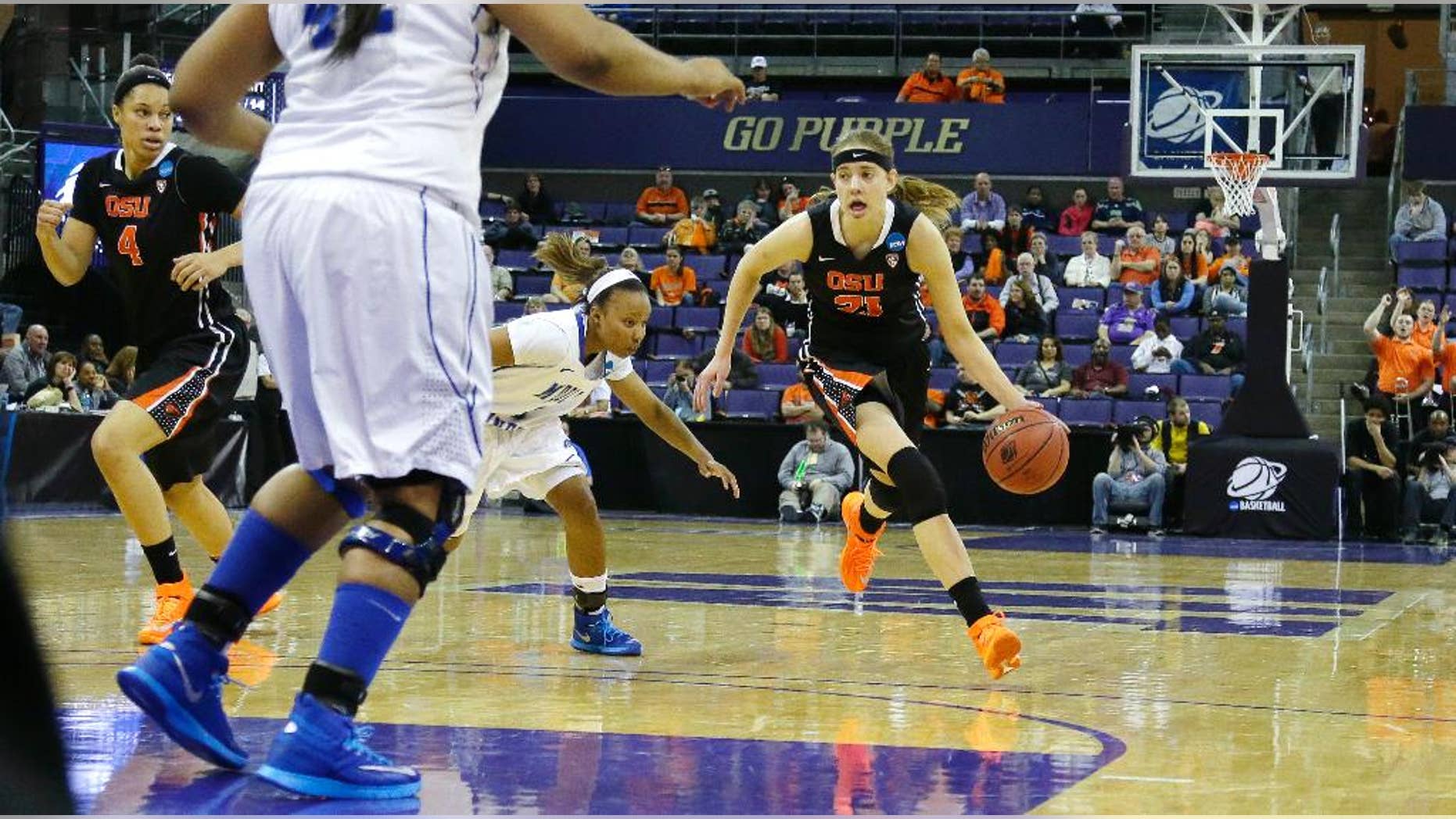 Oregon State's Sydney Wiese (21) drives past Middle Tennessee State's Ty Petty, second from right, in the first half of a first-round game in the NCAA women's college basketball tournament, Sunday, March 23, 2014, in Seattle. Oregon State beat Middle Tennessee 55-36. (AP Photo/Ted S. Warren)