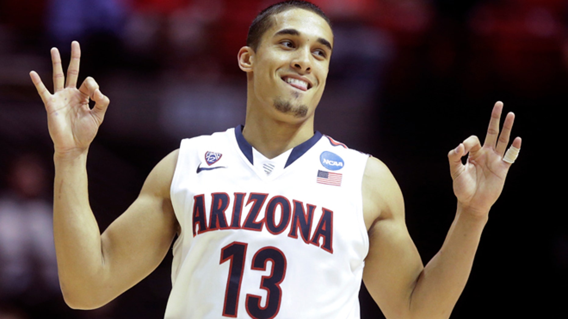 Johnson gestures after making a three-point basket against Gonzaga Sunday, March 23, 2014, in San Diego.
