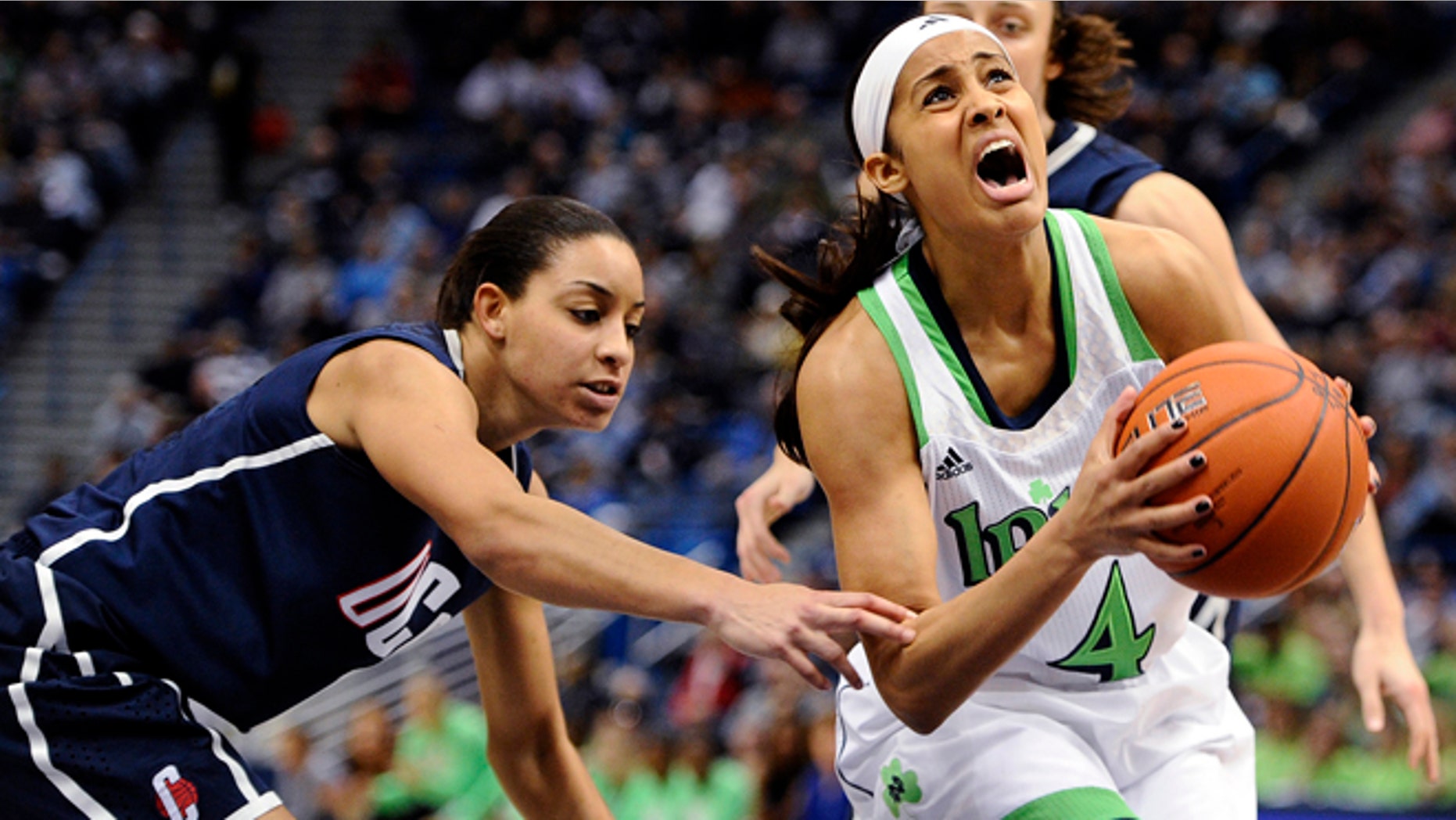 In this March 12, 2013, file photo, Notre Dame's Skylar Diggins (4) is fouled by Connecticut's Bria Hartley, left, in the first half of an NCAA college basketball game in the final of the Big East Conference tournament in Hartford, Conn.