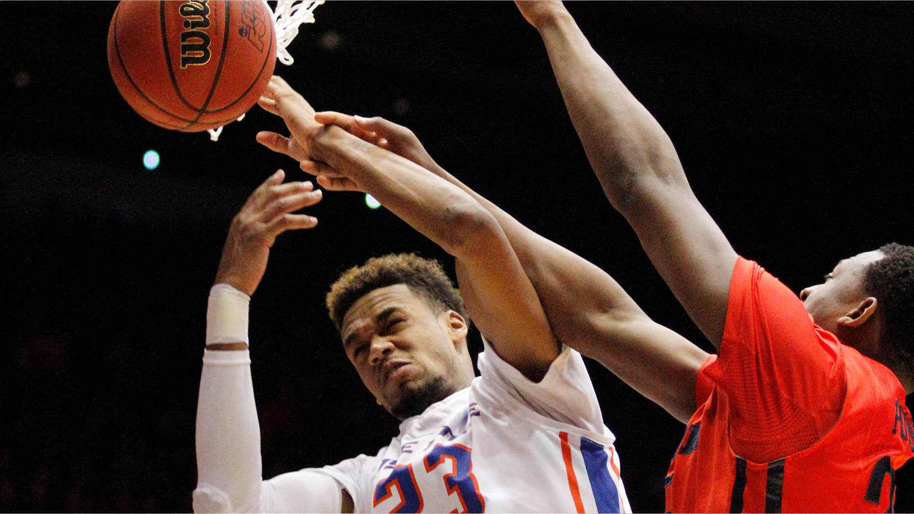 March 18, 2015: Boise State's James Webb III (23) is hit by Dayton's Kendall Pollard in the first half of a first round NCAA tournament basketball game.