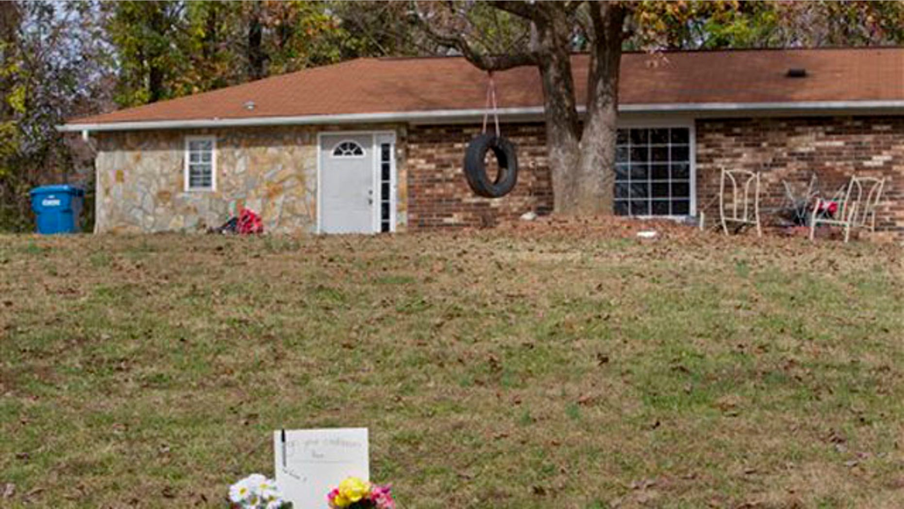 A memorial stands in front of a house on Cocoa Drive, where Mary Ann Holder is believed to have shot one of her sons, his girlfriend, and a niece and nephew, near Greensboro, N.C., Monday, Nov. 21, 2011.