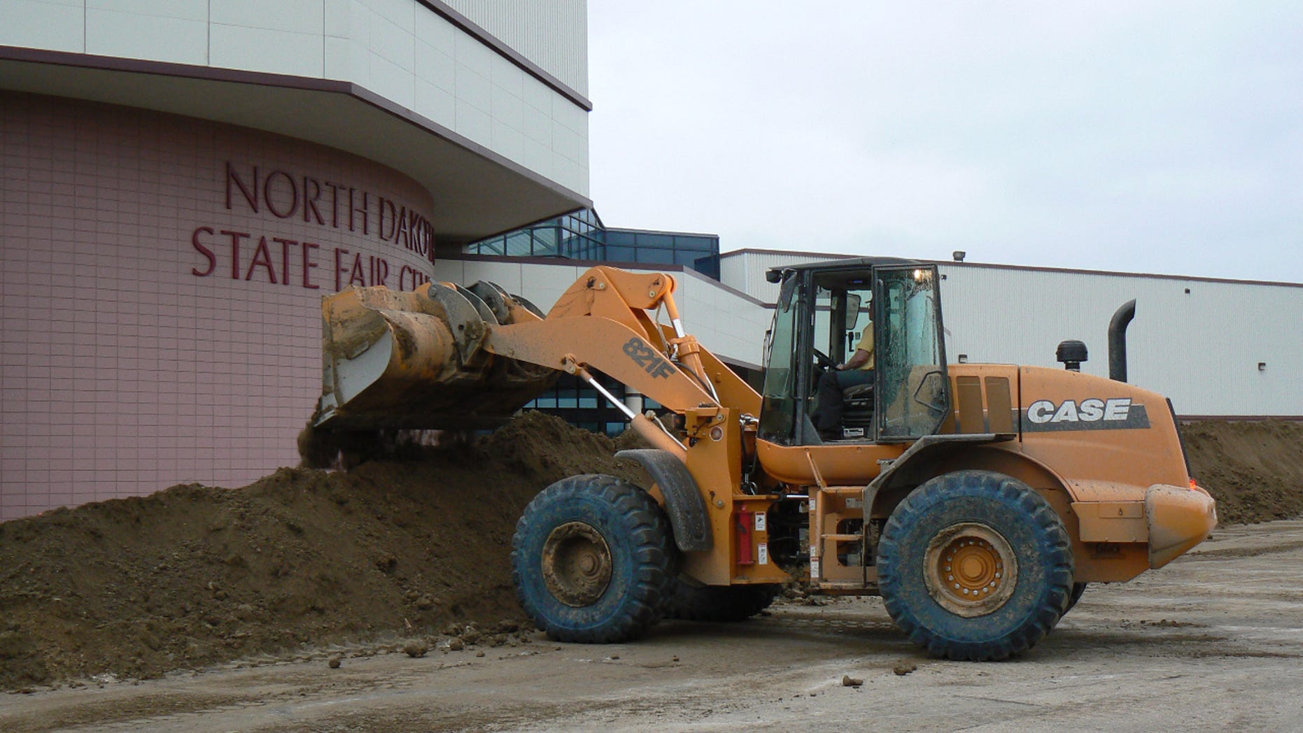 June 20: Dike work began late Monday to protect the North Dakota State Fair Center in Minot, N.D. The rising level of the Souris River is expected to inundate the State Fairgrounds, which are located in east Minot.