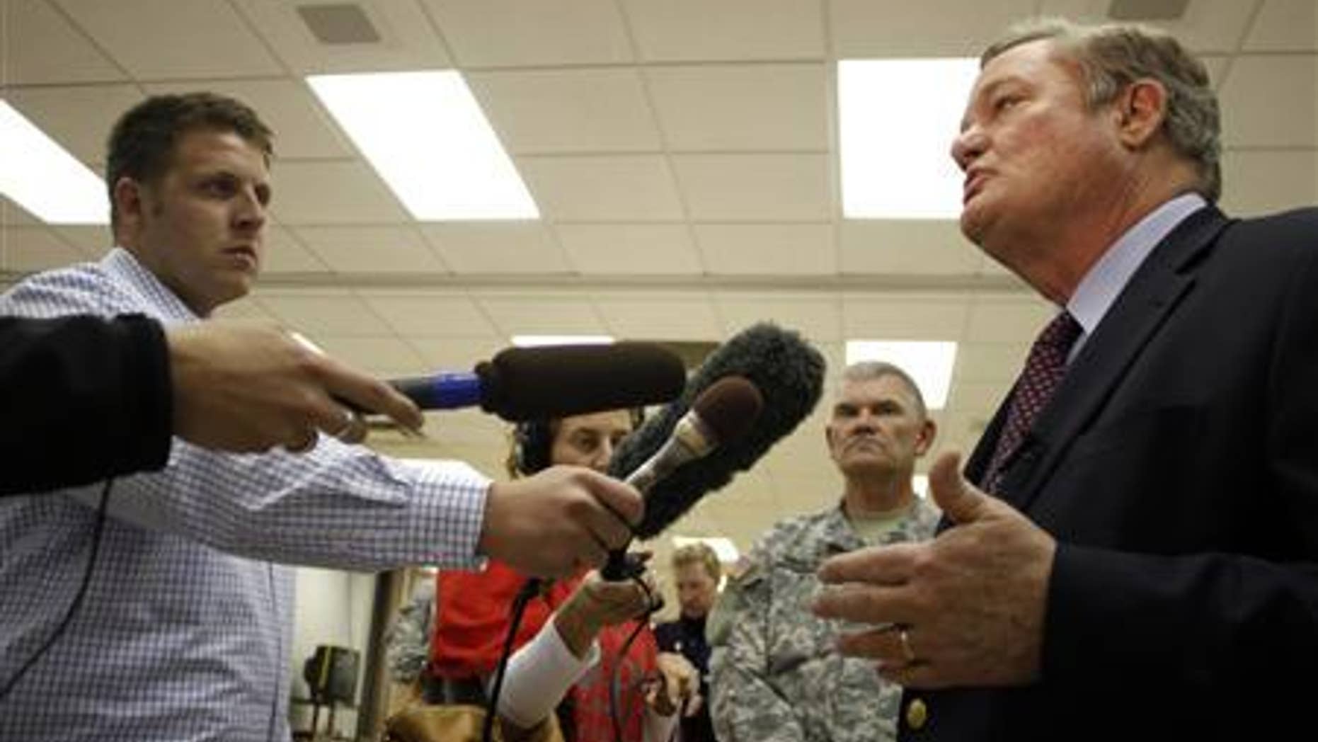 North Dakota Governor Jack Dalrymple (R) speaks with the media at the FEMA Disaster Recovery Center in Minot, North Dakota, June 27, 2011. REUTERS/Allen Fredrickson