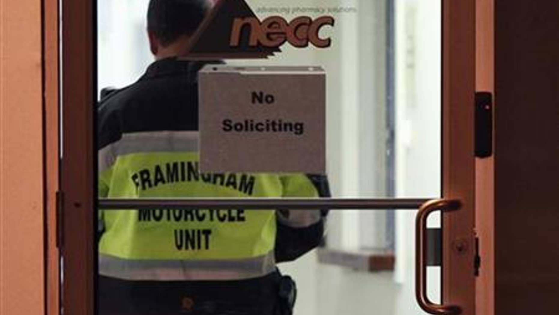 A Framingham Motorcycle Unit officer stands by while federal agents search New England Compounding Center in Framingham, Massachusetts October 16, 2012. (REUTERS/Dominick Reuter)
