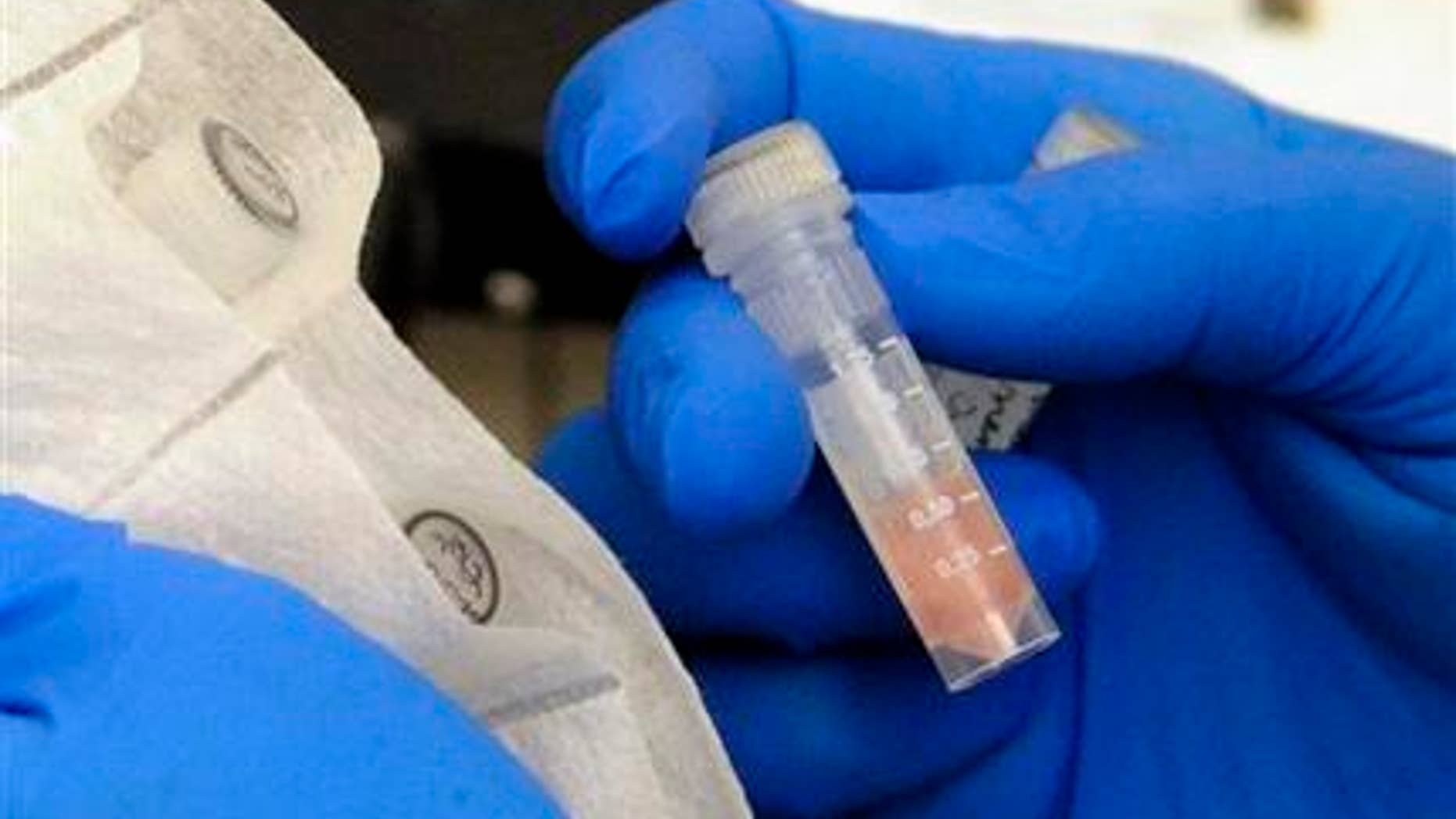 Oct. 9, 2012: Laboratory technician Ruth Rutledge packages cerebrospinal fluid of three confirmed meningitis cases in Minn., to send to the CDC for further testing, at the Minnesota Department of Health in St. Paul, Minn. (AP Photo/Hannah Foslien)