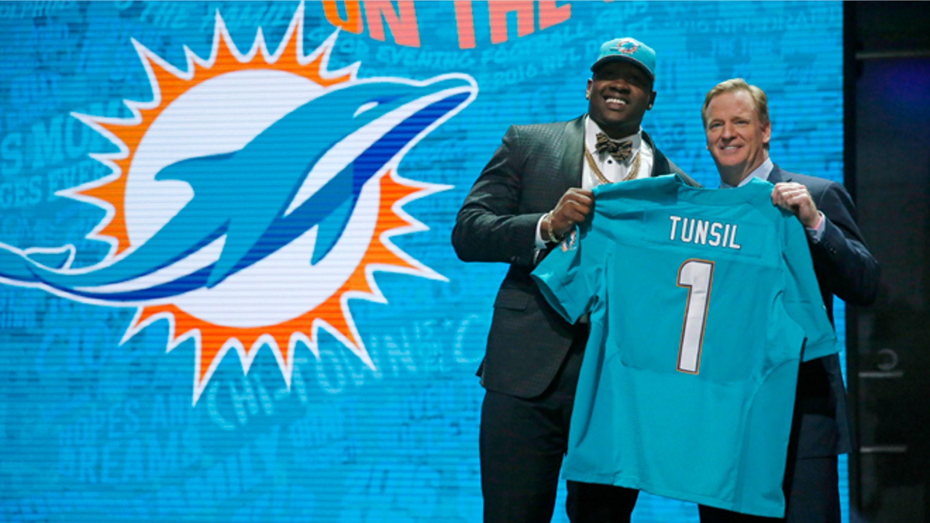 Mississippis Laremy Tunsil poses for photos with NFL commissioner Roger Goodell after being selected by the Miami Dolphins as the 13th pick in the first round of the 2016 NFL football draft, Thursday, April 28, 2016, in Chicago. (AP Photo/Charles Rex Arbogast)