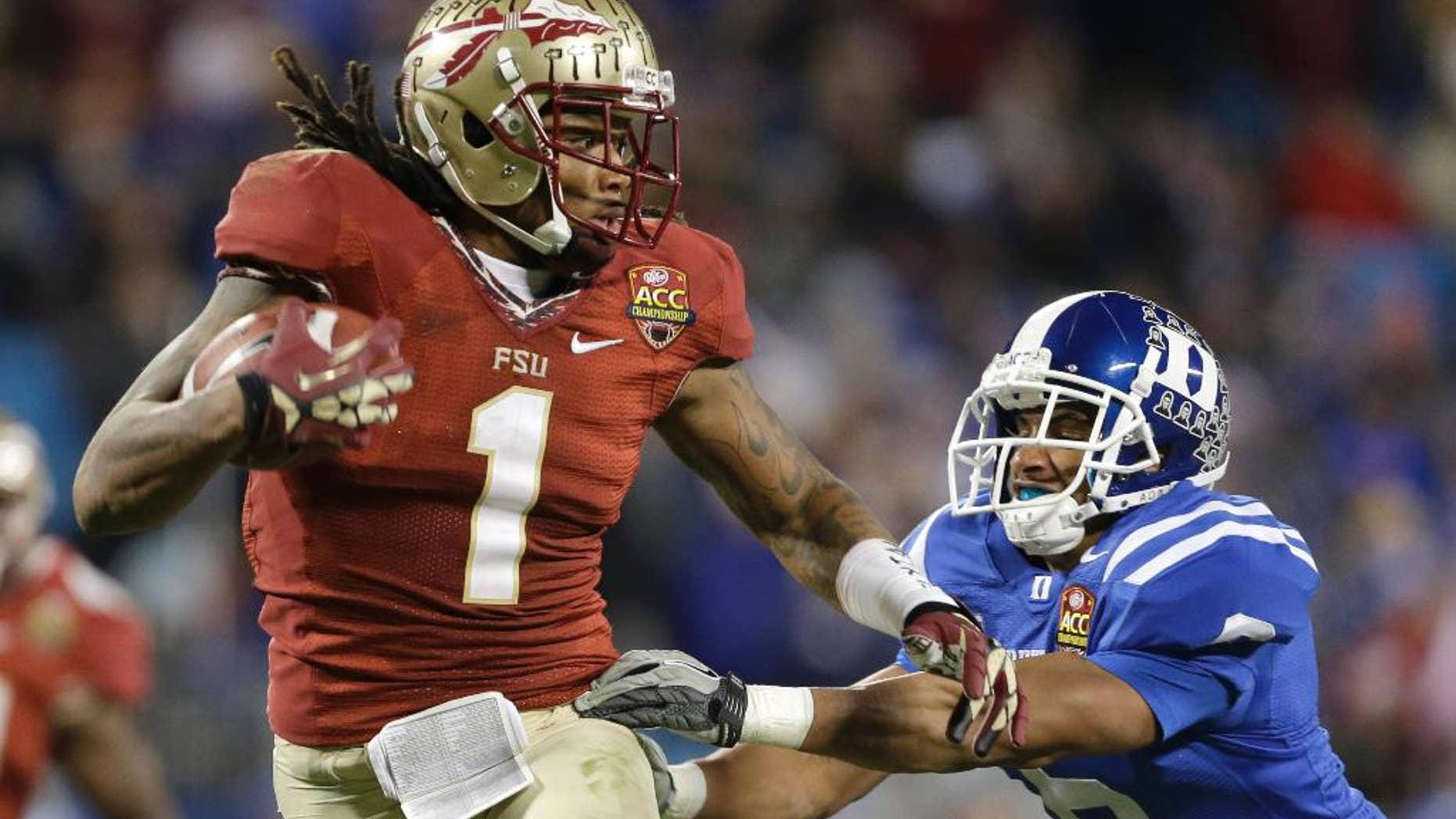 FILE - In this Dec. 7 2013, file photo, Florida State's Kelvin Benjamin (1) runs past Duke's Ross Cockrell (6) for a touchdown in the second half of the Atlantic Coast Conference Championship NCAA football game in Charlotte, N.C. Benjamin was selected in the first round, 28th overall, by the Carolina Panthers in the NFL draft on Thursday, May 8, 2014. (AP Photo/Bob Leverone, File)