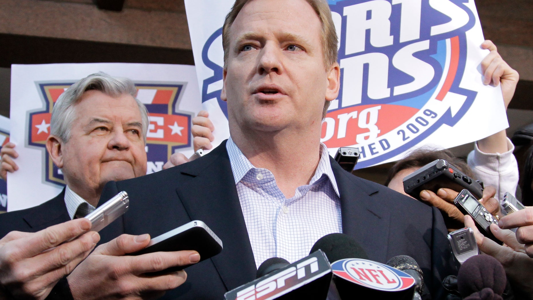 NFL Commissioner Roger Goodell, joined at left by Carolina Panthers owner Jerry Richardson, speaks with reporters as negotiations between the NFL owners and players go unresolved, at the Federal Mediation and Conciliation Service in Washington, Friday, March 11, 2011.