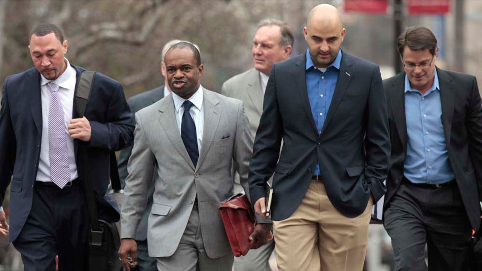 NFL Players Association (NFLPA) Executive Director DeMaurice Smith, second from left, flanked by Pittsburgh Steelers Charlie Batch, left, NFLPA spokesman George Atallah, second from right, and others, arrive for the first negotiating session involving a federal mediator, Friday, Feb. 18, 2011, in Washington. (AP Photo/Alex Brandon)