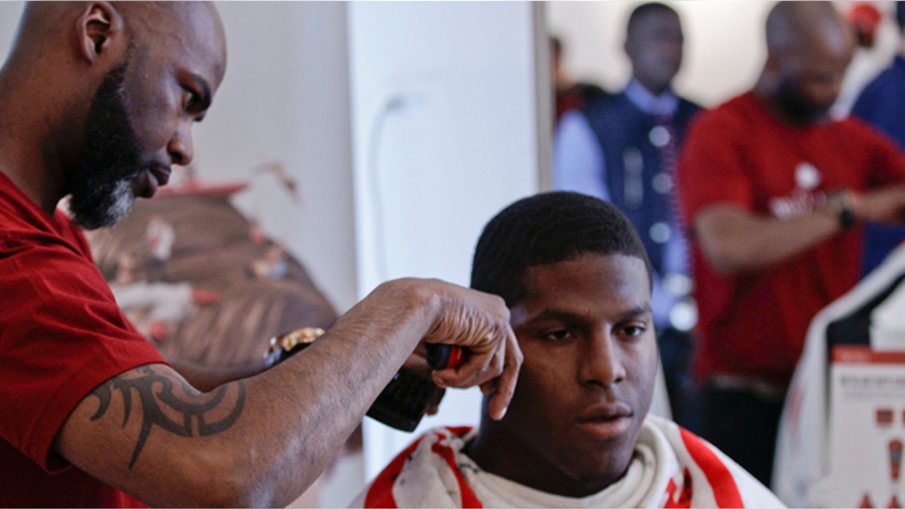 This May 6, 2014 photo shows NFL Draft prospect Kony Ealy, a defensive end from Missouri, getting a haircut during the 5th Annual NFL Pre-Draft Gifting & Style Suite at the Sean John showroom in New York. Ealy is among dozens of prospects on the National Football League's annual draft, with 32 players per round and seven rounds, beginning Thursday night at Radio City. Ealy is projected to go late in the first round. (AP/Frank Franklin II)