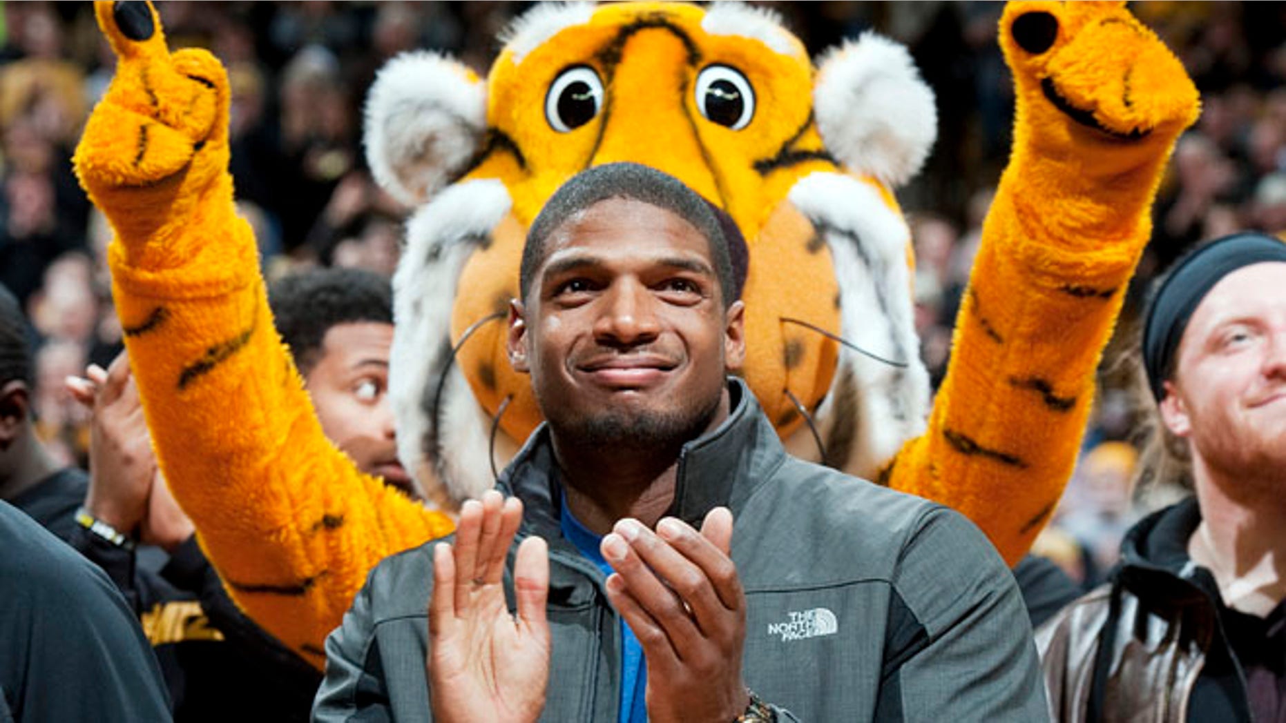 Feb. 15, 2014: Missouri's All-American defensive end Michael Sam claps during the Cotton Bowl trophy presentation at halftime of an NCAA college basketball game between Missouri and Tennessee.