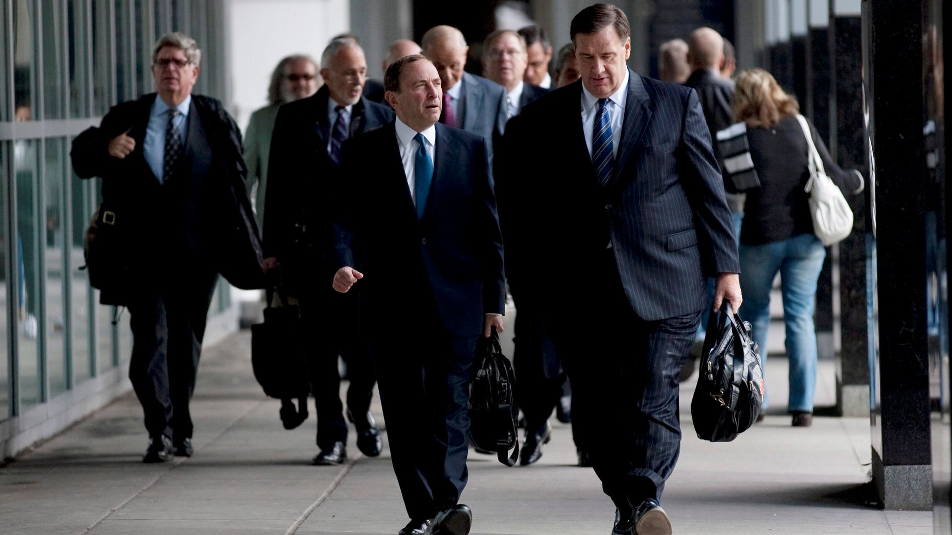 Oct. 18, 2012 File of NHL Commissioner Gary Bettman, left foreground, and Calgary Flames co-owner Murray Edwards arrive for negotiations with the Players Association in Toronto.