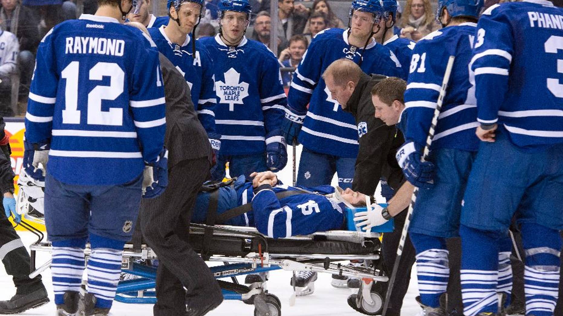 Toronto Maple Leafs' Paul Ranger is taken off the ice on a stretcher after hitting the boards head first from a check by Tampa Bay Lightning's Alex Killorn during first period NHL action in Toronto on Wednesday March 19, 2014. (AP Photo/The Canadian Press, Frank Gunn)