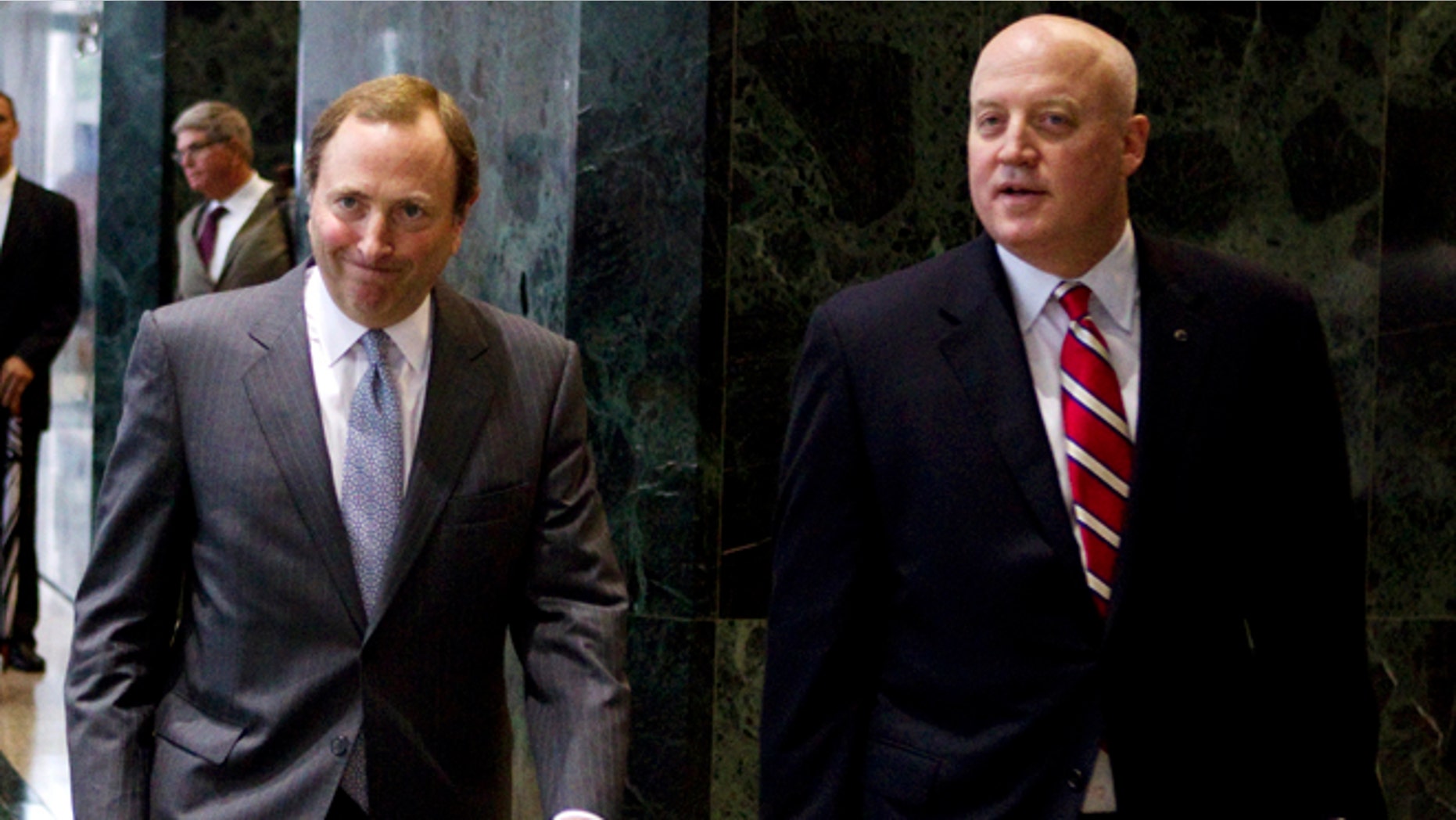 Aug. 14, 2012: This file photo shows NHL commissioner Gary Bettman, left, and Bill Daly, deputy commissioner and chief legal officer, following collective bargaining talks in Toronto.