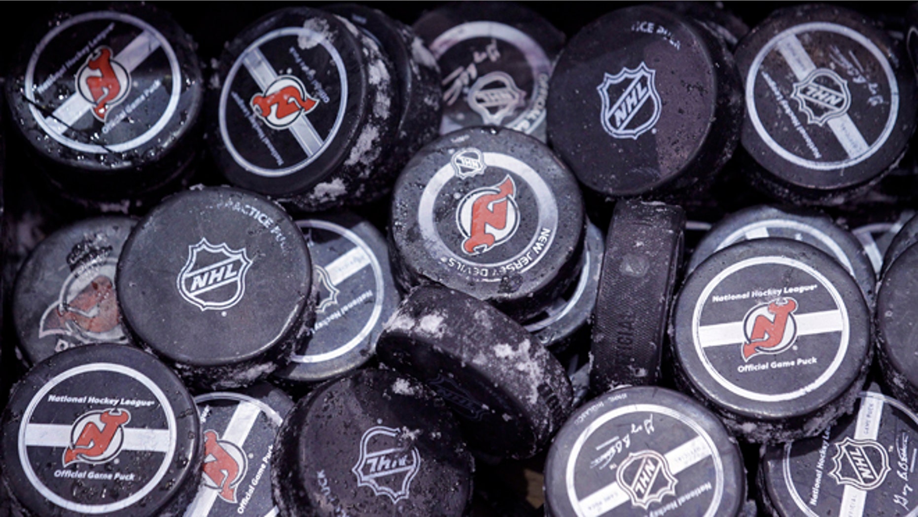 May 15, 2012: In this file photo, ice covered hockey pucks are shown at the New Jersey Devils practice rink in Newark, N.J.