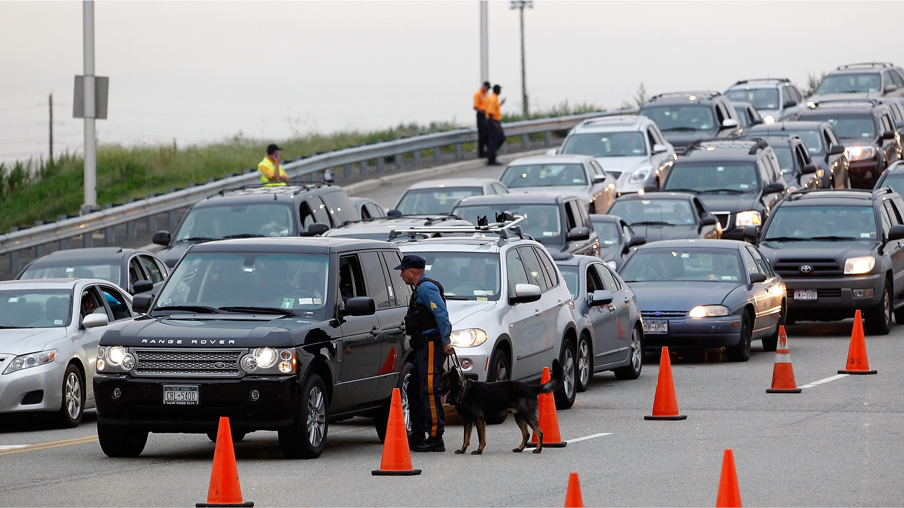 EAST RUTHERFORD, NJ - SEPTEMBER 11: K-9 State Troopers and stadium security inspect cars with dogs as they enter the stadium for the NFL season opener between the New York Jets and Dallas Cowboys at MetLife Stadium on September 11, 2011 in East Rutherford, New Jersey. Extra security is in place at the stadium due to the 10 year anniversary of the 9/11 terror attacks. (Photo by Jeff Zelevansky/Getty Images)
