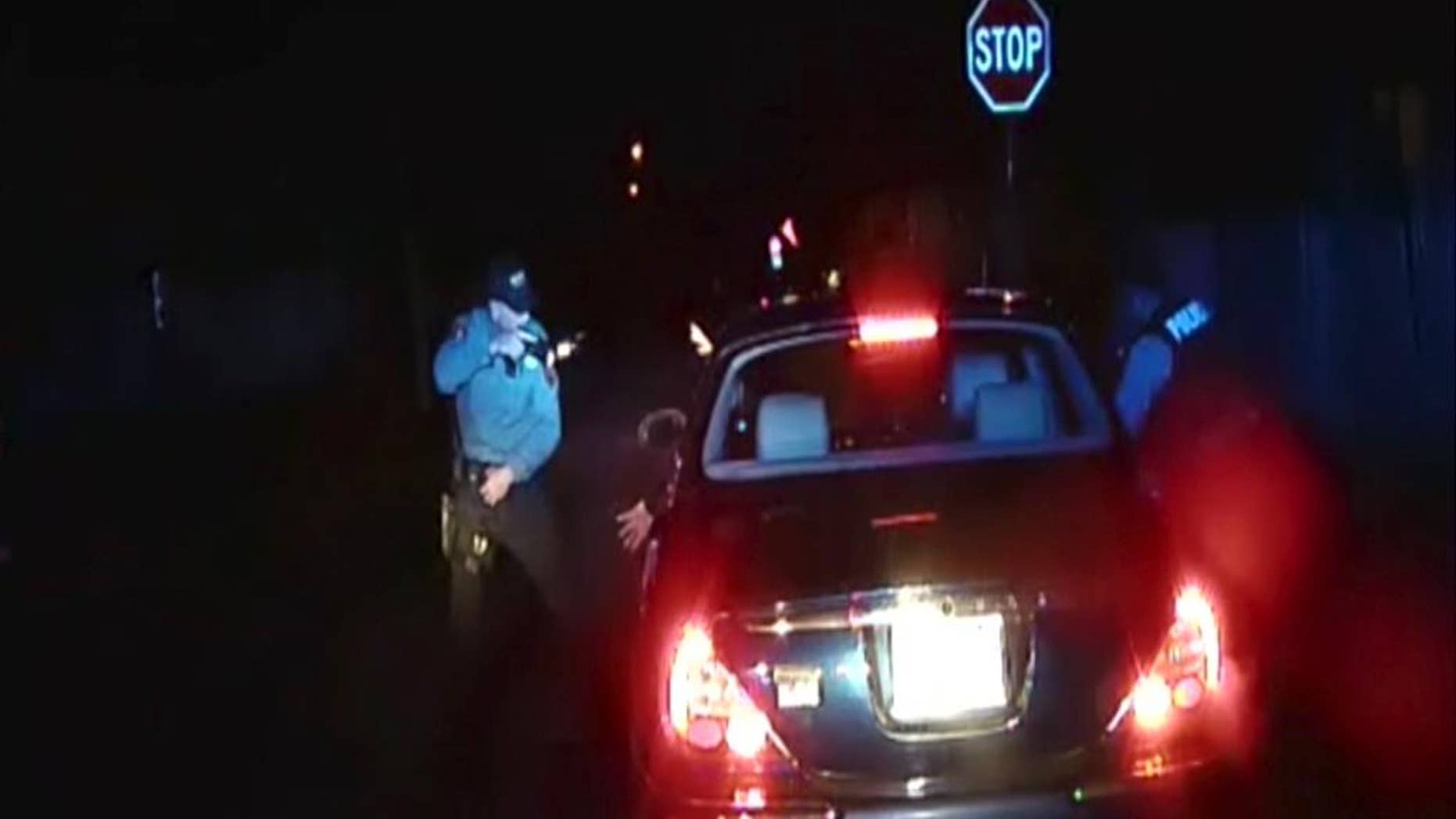 FILE - In this frame grab from an officer's dashboard camera taken Dec. 30, 2014, and provided by the Bridgeton, N..J. Police Department, police officers Braheme Days and Roger Worley stand near a car they pulled over for running a stop sign in Bridgeton. A grand jury has voted not to file charges against the two police officers for fatally shooting a man who defied orders by stepping out of a car with his hands raised during a traffic stop, a killing captured by their patrol car's dashboard camera, prosecutors said Thursday, Aug. 20, 2015. (AP Photo/Bridgeton Police Department, File)