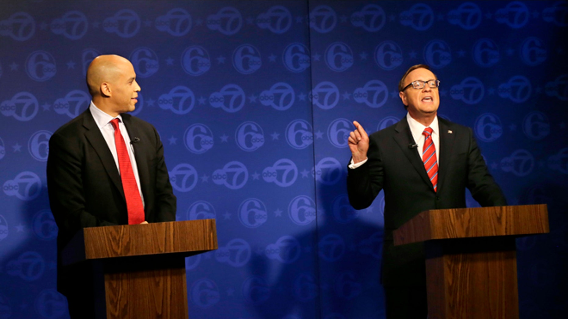 Oct. 4, 2013: Cory Booker (l.) looks on as Republican Steve Lonegan answers a question during their first debate of the U.S. Senate campaign in Trenton, N.J. Booker is Newark's two-term mayor. Lonegan is the former state director of a conservative advocacy group, Americans for Prosperity, and former mayor of Bogota, N.J.