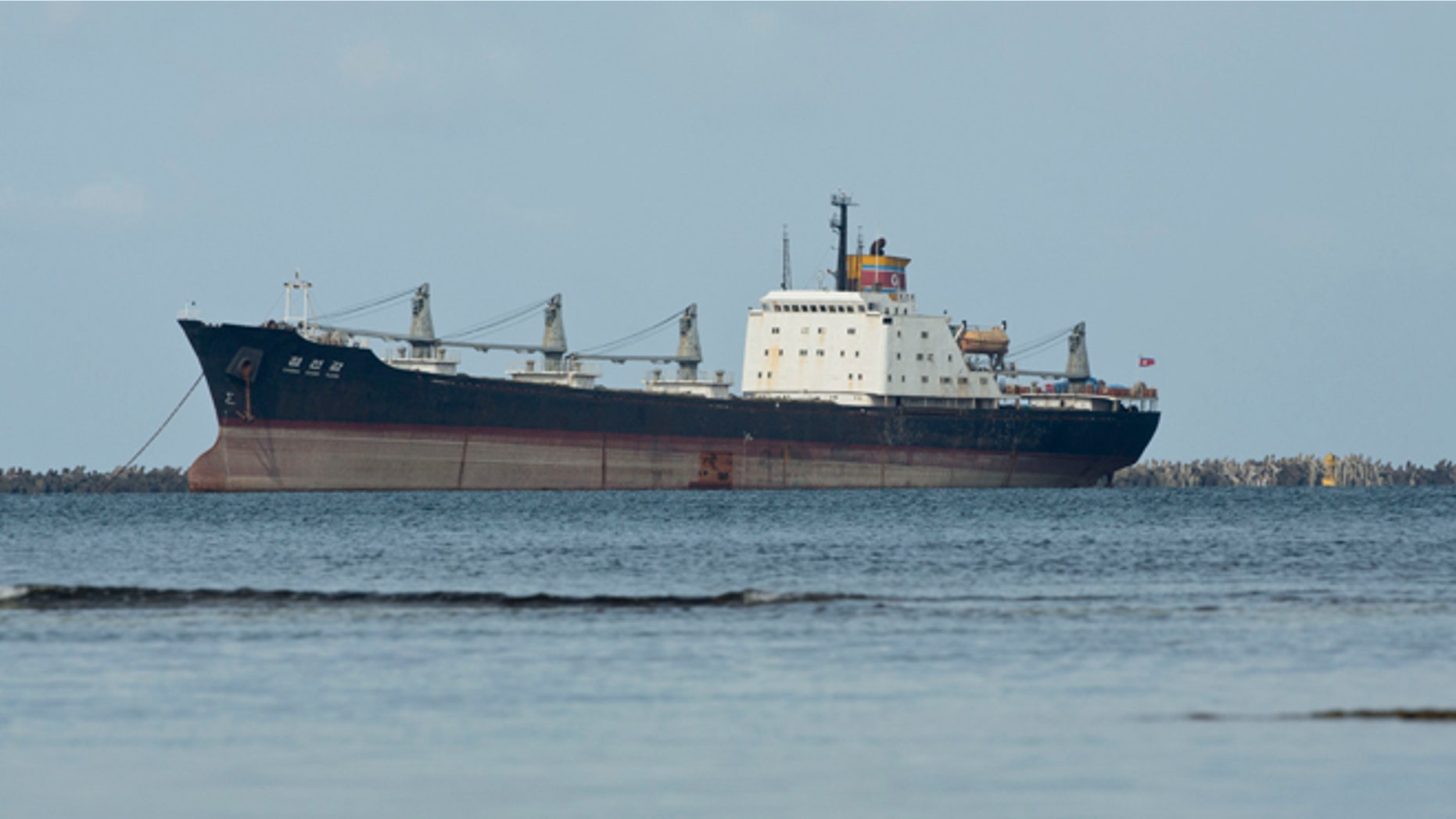 FILE - In this Nov. 27, 2013 file photo, the North Korean-flagged cargo ship Chong Chon Gang sits in Sherman Bay near Colon City, Panama. Panama Canal officials say on Saturday, Feb. 8, 2014 that the seized ship is free to leave because the owner has paid a fine. Three of the ship's operators still face charges, while 32 crew members are free to return to North Korea. The vessel was detained in July 2013 when a search revealed it was carrying weapons from Cuba. (AP Photo/Arnulfo Franco, File)