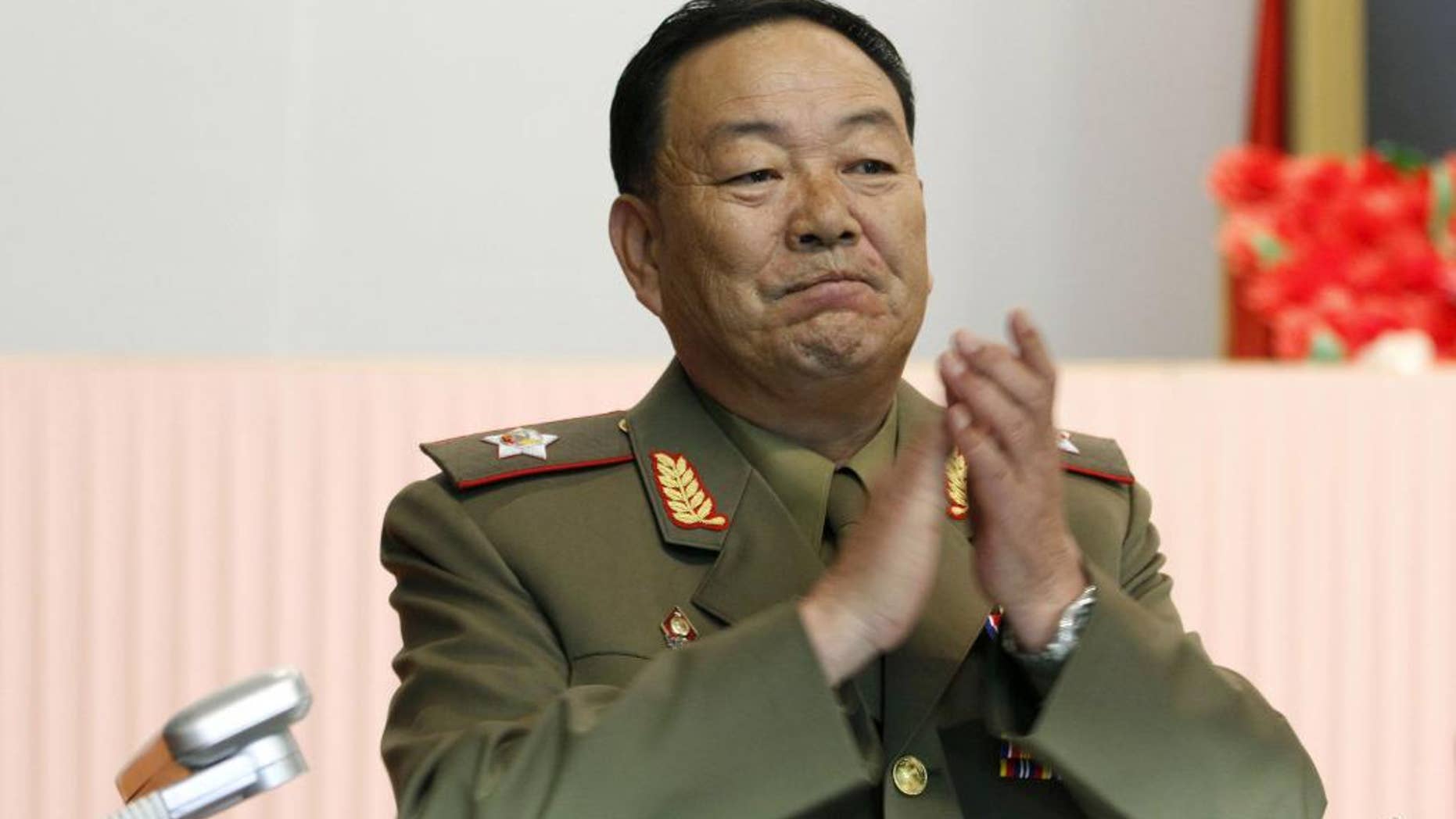 File-This July 18, 2012, file photo shows Vice Marshal Hyon Yong Chol applauding during a meeting announcing North Korean leader Kim Jong Un's new title of marshal, in Pyongyang, North Korea. North Korea has officially confirmed the purging of its defense chief two months after Seoul's spy service said he had been executed for disloyalty to leader Kim Jong Un, a South Korean official said Monday, July 12, 2015. South Korea's National Intelligence Service told lawmakers in May that People's Armed Forces Minister Hyon Yong Chol was killed by anti-aircraft gunfire for talking back to Kim, complaining about his policies and sleeping during a meeting. (AP Photo/Jon Chol Jin, File)