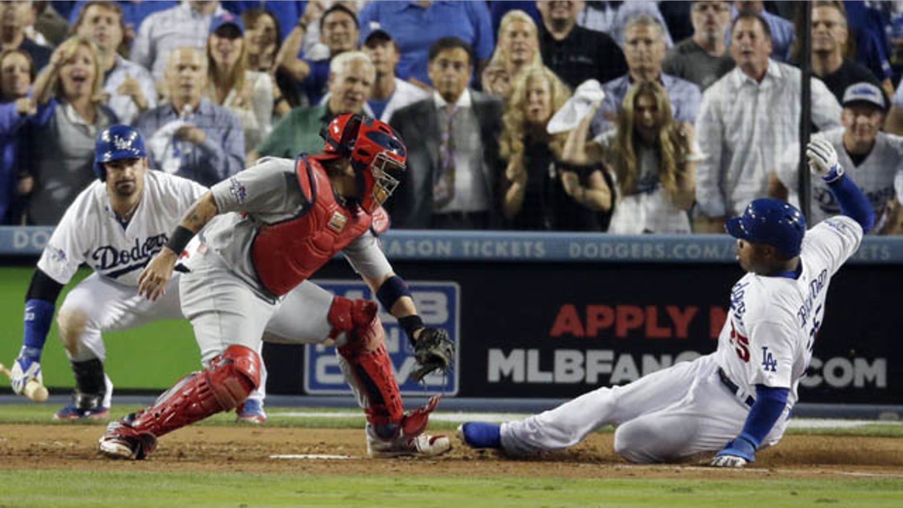 October 14, 2013: Carl Crawford slides safely past St. Louis Cardinals catcher Yadier Molina during the eighth inning of Game 3 of the National League baseball championship series Monday in Los Angeles. (AP Photo/Chris Carlson)