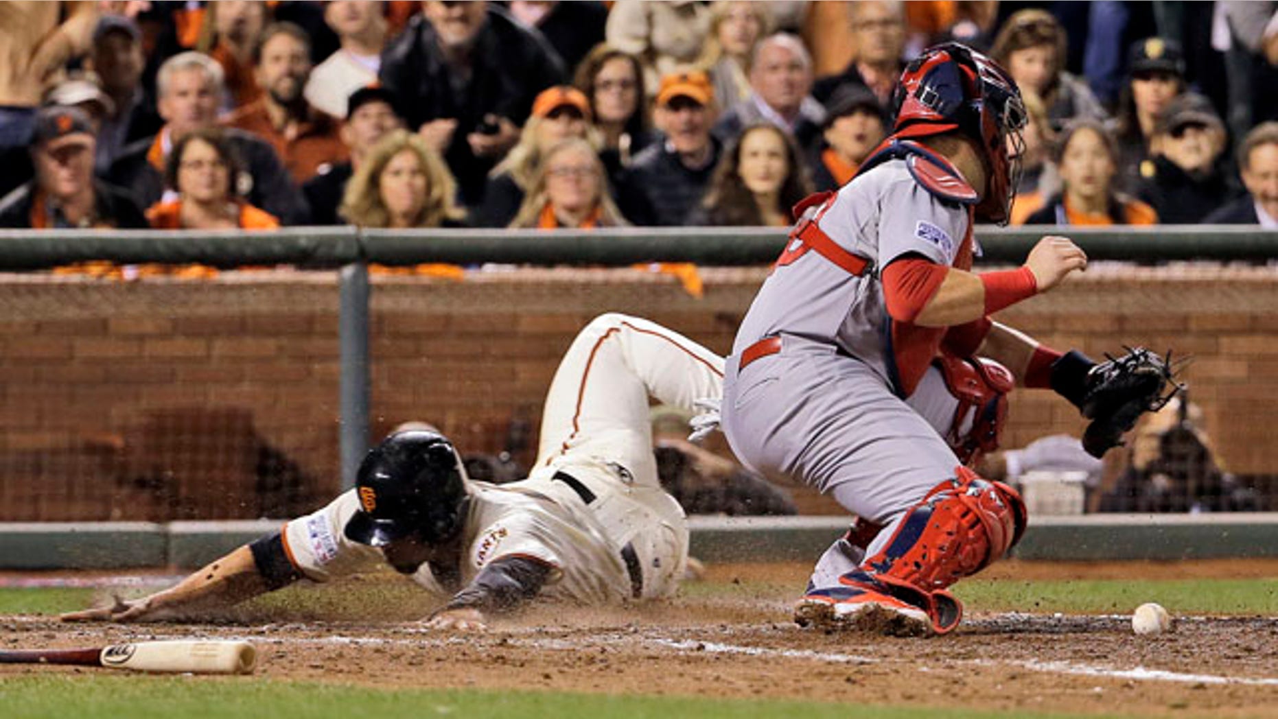 October 15, 2014: San Francisco Giants' Juan Perez, left, scores past St. Louis Cardinals catcher A.J. Pierzynski on a hit by Gregor Blanco during the sixth inning of Game 4 of the National League baseball championship series in San Francisco. (AP Photo/David J. Phillip)